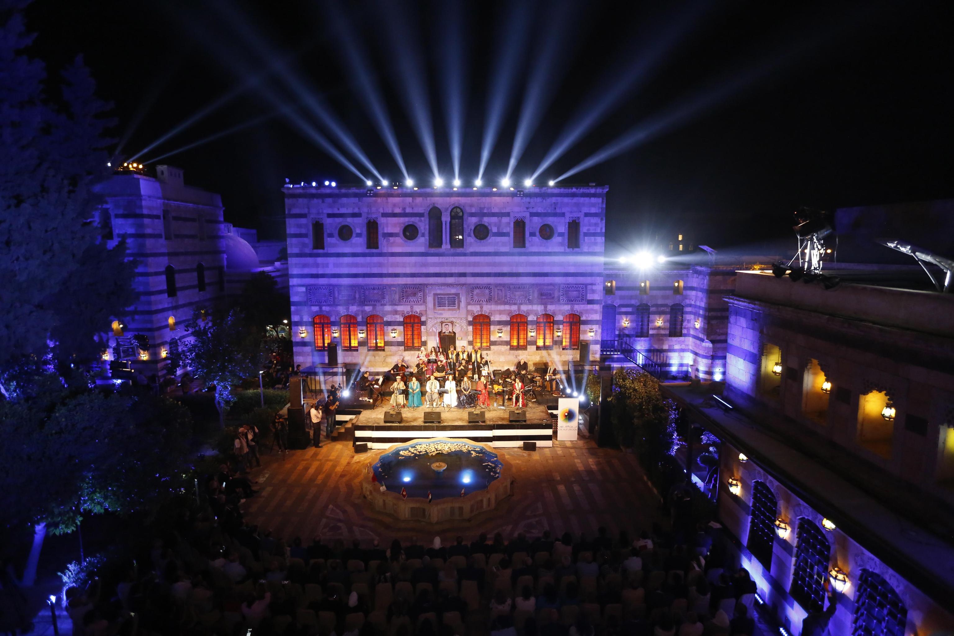 epa07840828 Singers from Arab and European countries participate in a concert held at the historical Azm Palace in the old city of Damascus, Syria, 13 August 2019. The concert, titled 'the journey of al-Mowashah (a kind of poetic singing dates back to the 9th century) from Andalusia to al-Sham'. The event is organised by the Syrian ministries of culture and tourism with the cooperation of Ein al-Fonoun Association.  EPA/YOUSSEF BADAWI