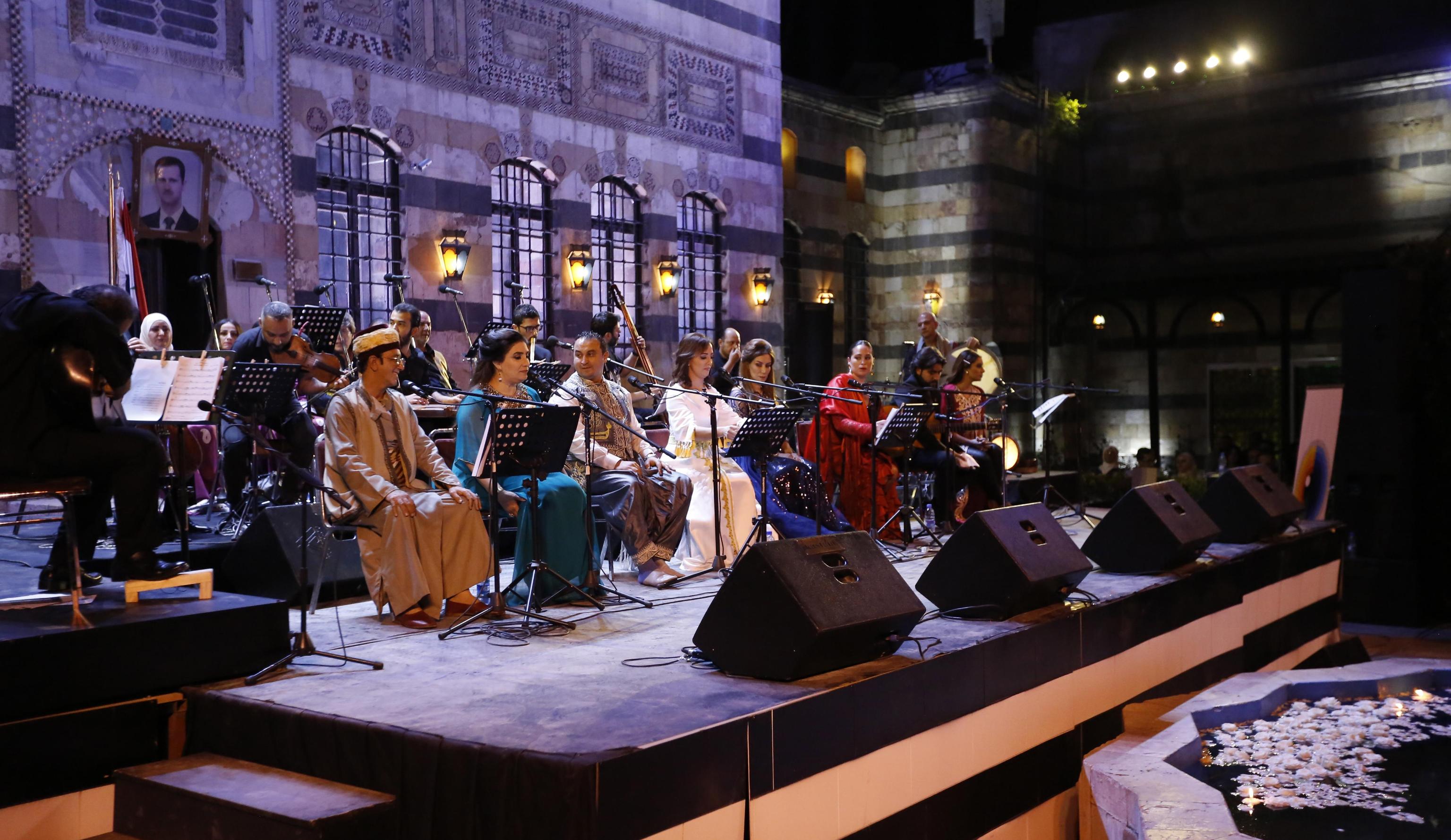 epa07840822 Singers from Arab and European countries participate in a concert held at the historical Azm Palace in the old city of Damascus, Syria, 13 August 2019. The concert, titled 'the journey of al-Mowashah (a kind of poetic singing dates back to the 9th century) from Andalusia to al-Sham'. The event is organised by the Syrian ministries of culture and tourism with the cooperation of Ein al-Fonoun Association.  EPA/YOUSSEF BADAWI