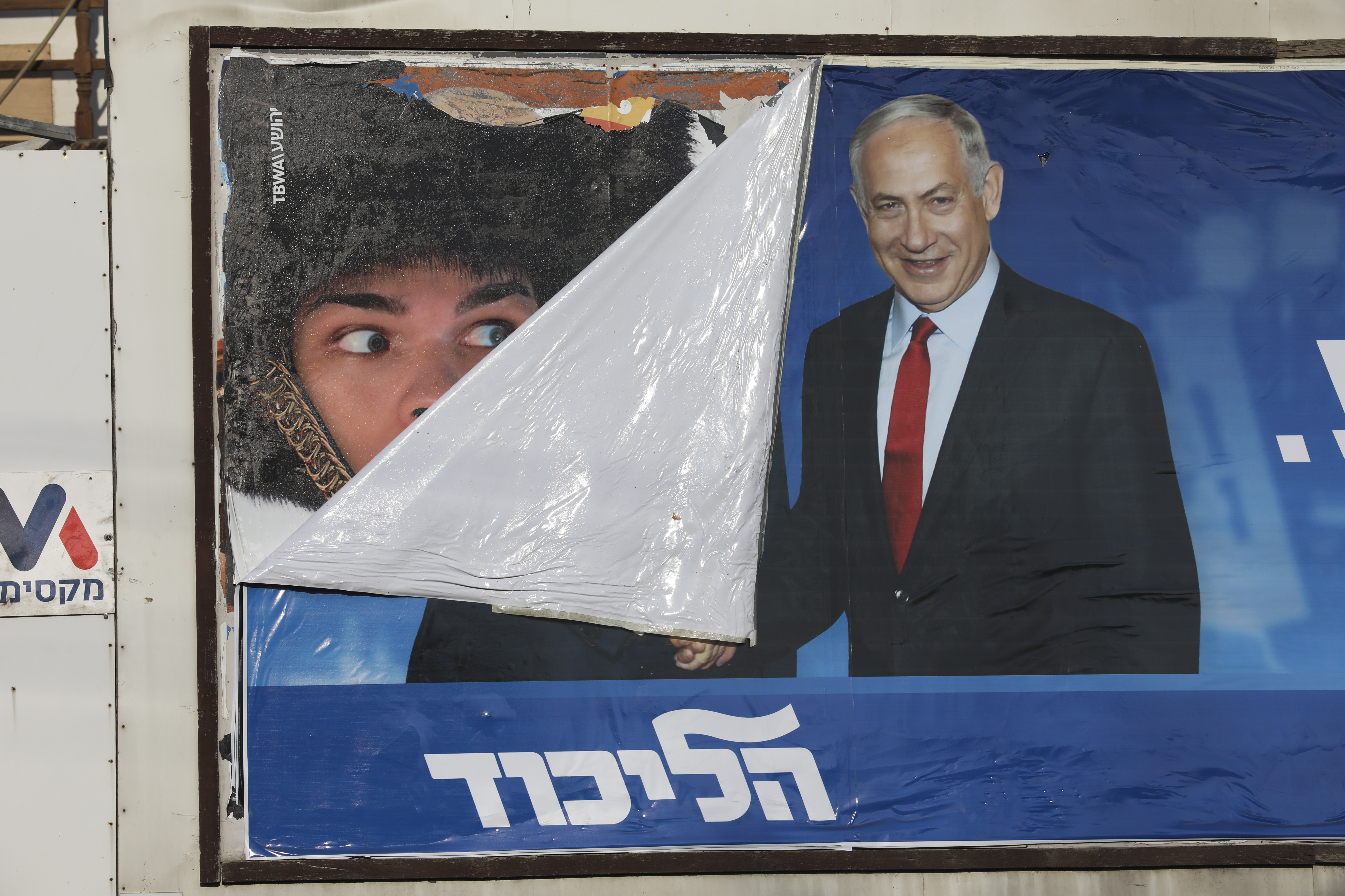 A campaign poster for Israeli Prime Minister Benjamin Netanyahu is seen in Bnei Brak, Israel, Tuesday, Sept. 17, 2019. Israelis began voting Tuesday in an unprecedented repeat election that will decide whether longtime Prime Minister Benjamin Netanyahu stays in power despite a looming indictment on corruption charges. .(AP Photo/Oded Balilty)