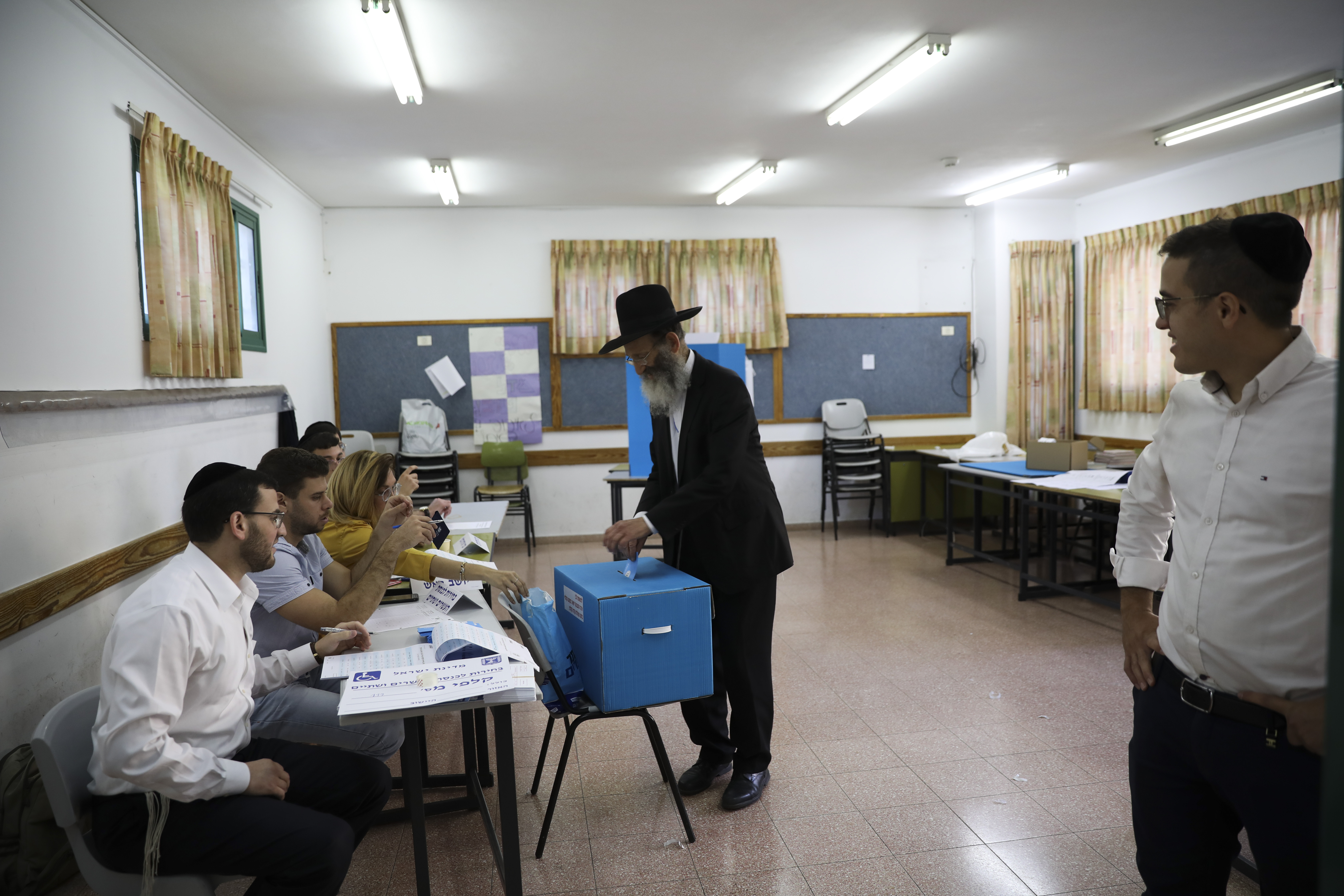 A man votes in Bnei Brak, Israel, Tuesday, Sept. 17, 2019. Israelis began voting Tuesday in an unprecedented repeat election that will decide whether longtime Prime Minister Benjamin Netanyahu stays in power despite a looming indictment on corruption charges. .(AP Photo/Oded Balilty)