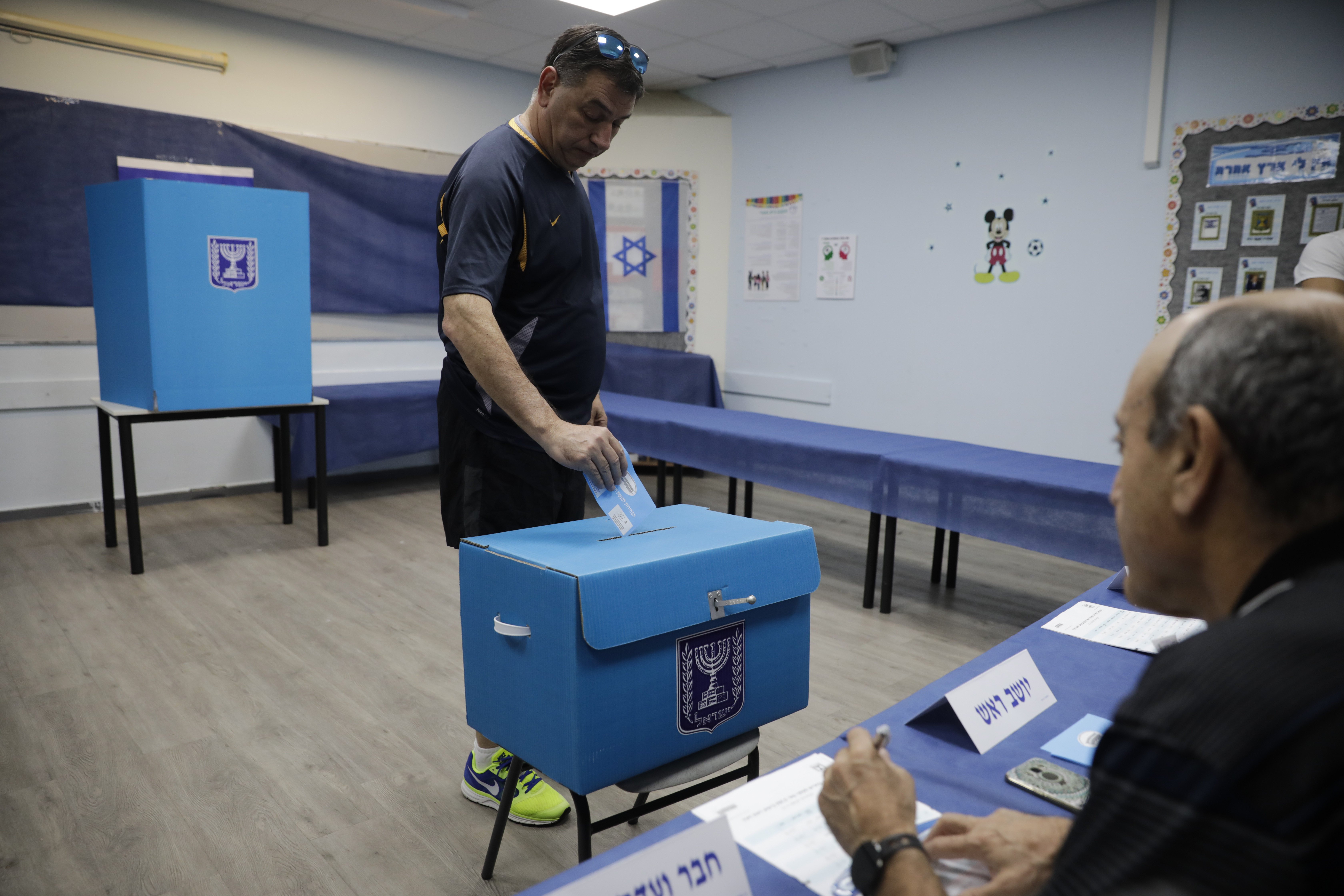 A man votes in Rosh Haayin, Israel, Tuesday, Sept. 17, 2019. Israelis began voting Tuesday in an unprecedented repeat election that will decide whether longtime Prime Minister Benjamin Netanyahu stays in power despite a looming indictment on corruption charges. (AP Photo/Sebastian Scheiner)