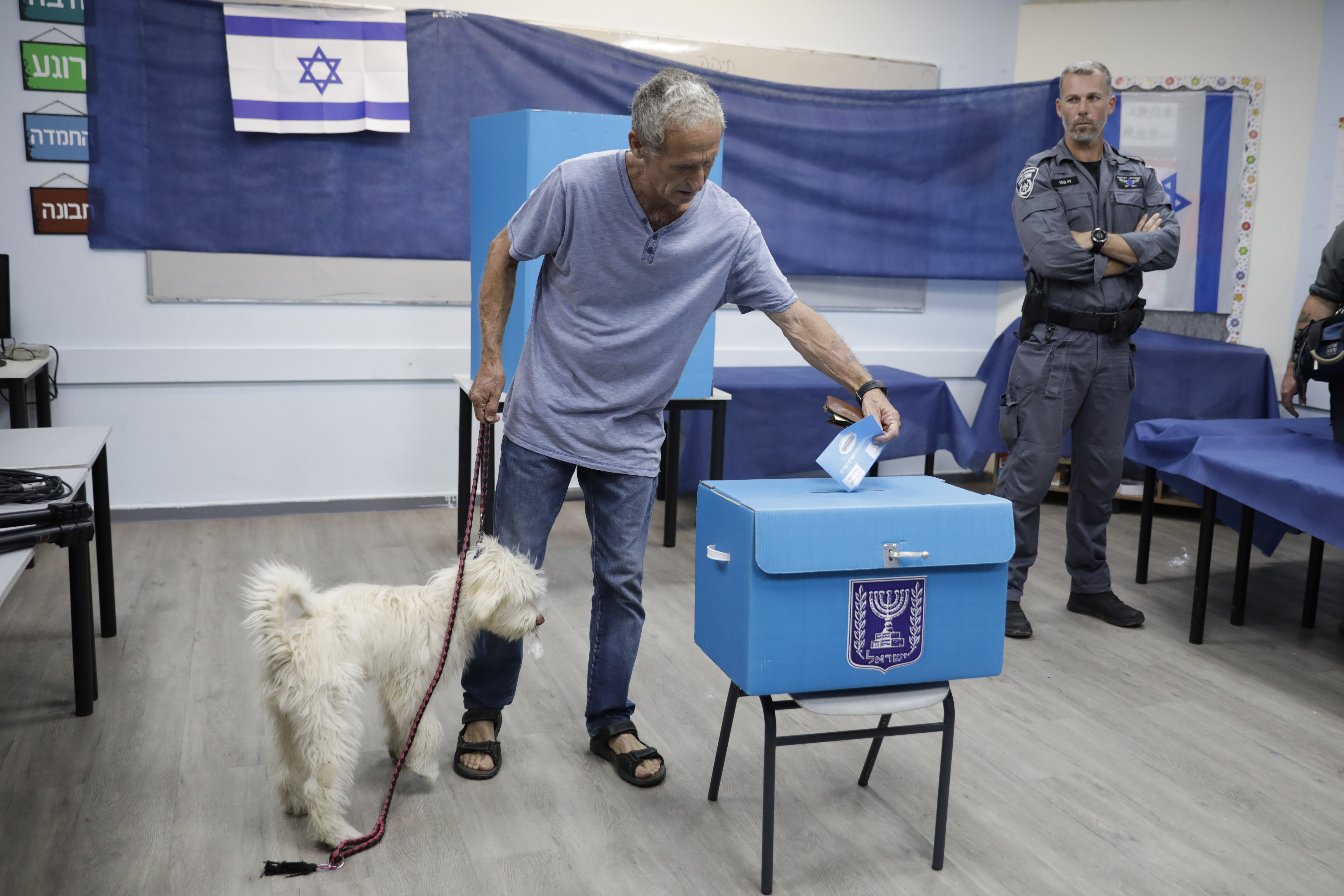 A man votes at a poling station in Rosh Haayin, Israel, Tuesday, Sept. 17, 2019. Israelis began voting Tuesday in an unprecedented repeat election that will decide whether longtime Prime Minister Benjamin Netanyahu stays in power despite a looming indictment on corruption charges. (AP Photo/Sebastian Scheiner)