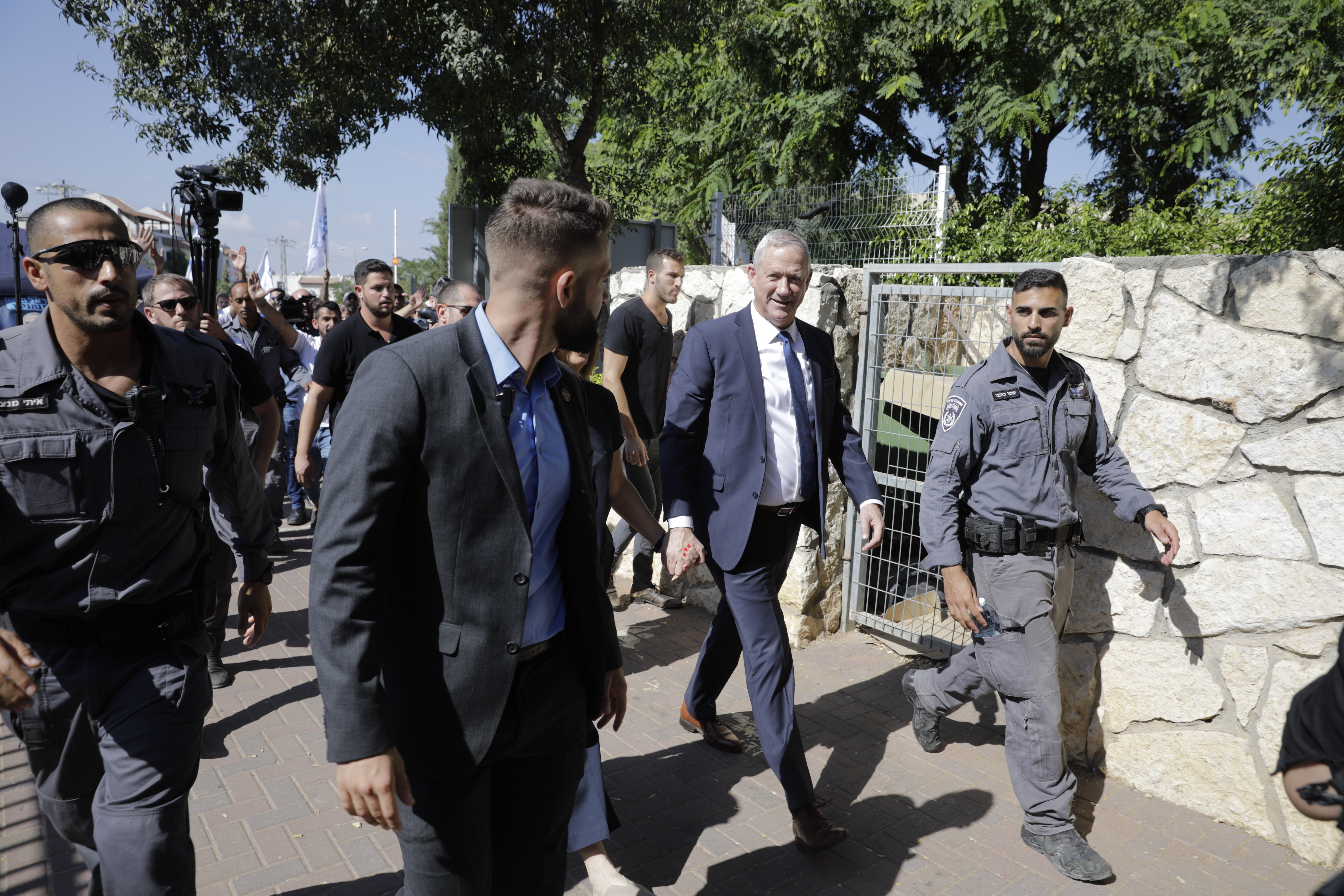 Blue and White party leader Benny Gantz leaves polling station in Rosh Haayin, Israel, Tuesday, Sept. 17, 2019. Israelis began voting Tuesday in an unprecedented repeat election that will decide whether longtime Prime Minister Benjamin Netanyahu stays in power despite a looming indictment on corruption charges. (AP Photo/Sebastian Scheiner)