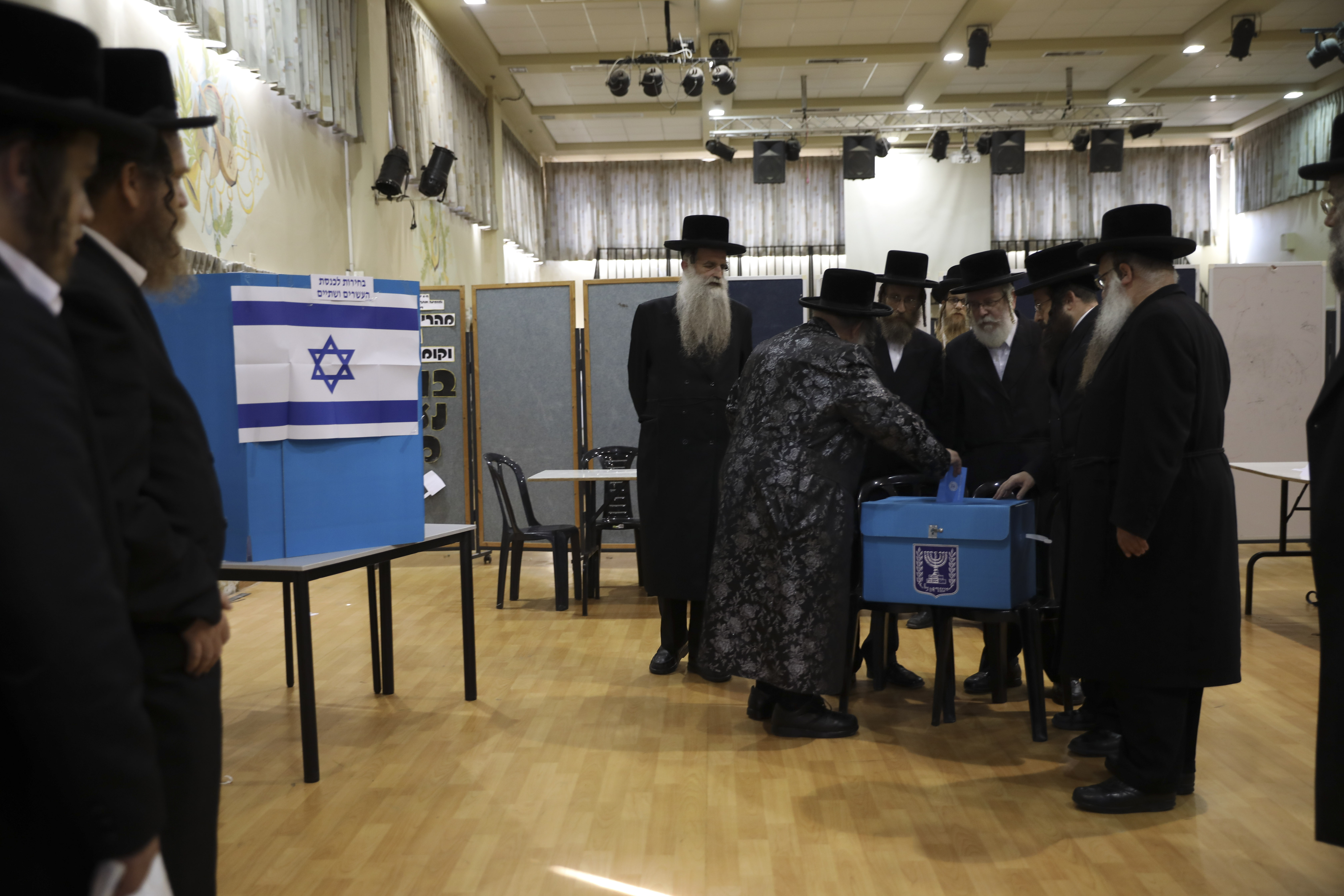 Ultra orthodox Jews watch Rabbi Israel Hager vote in Bnei Brak, Israel, Tuesday, Sept. 17, 2019. Israelis began voting Tuesday in an unprecedented repeat election that will decide whether longtime Prime Minister Benjamin Netanyahu stays in power despite a looming indictment on corruption charges. (AP Photo/Oded Balilty)