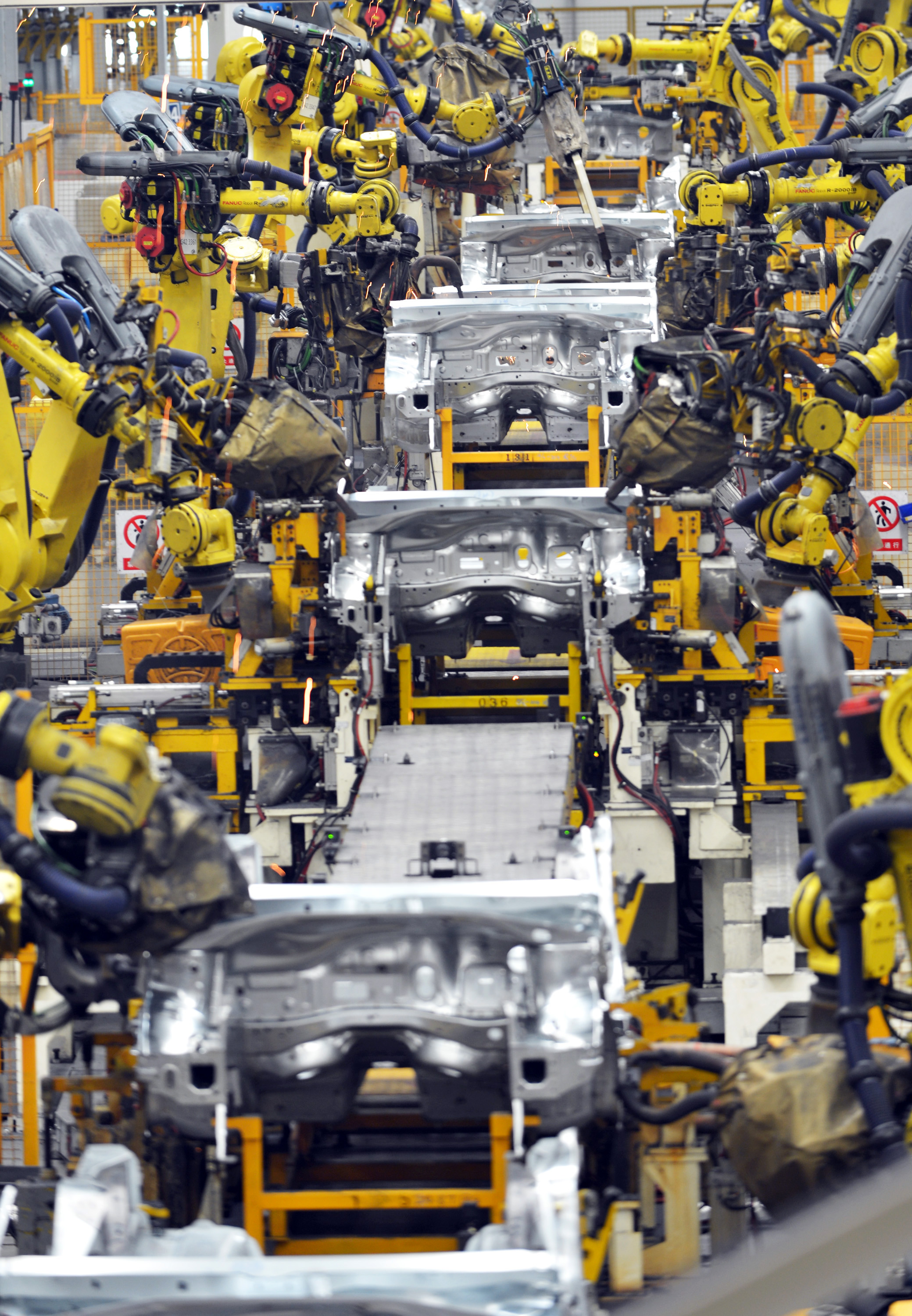 --FILE--Robot arms weld car parts at an auto plant of Dongfeng Peugeot Citroen Automobile Co., Ltd. in Wuhan city, central China's Hubei province, 24 September 2014.

For decades, manufacturers employed waves of young migrant workers from China's countryside to work at countless factories in coastal provinces, churning out cheap toys, clothing and electronics that helped power the country's economic ascent. Now, factories are rapidly replacing those workers with automation, a pivot that's encouraged by rising wages and new official directives aimed at helping the country move away from low-cost manufacturing as the supply of young, pliant workers shrinks. It's part of a broader overhaul of the economy as China seeks to vault into the ranks of wealthy nations. But it comes as the country's growth slows amid tepid global demand that's adding pressure on tens of thousands of manufacturers. With costs rising and profits shrinking, Chinese manufacturers 