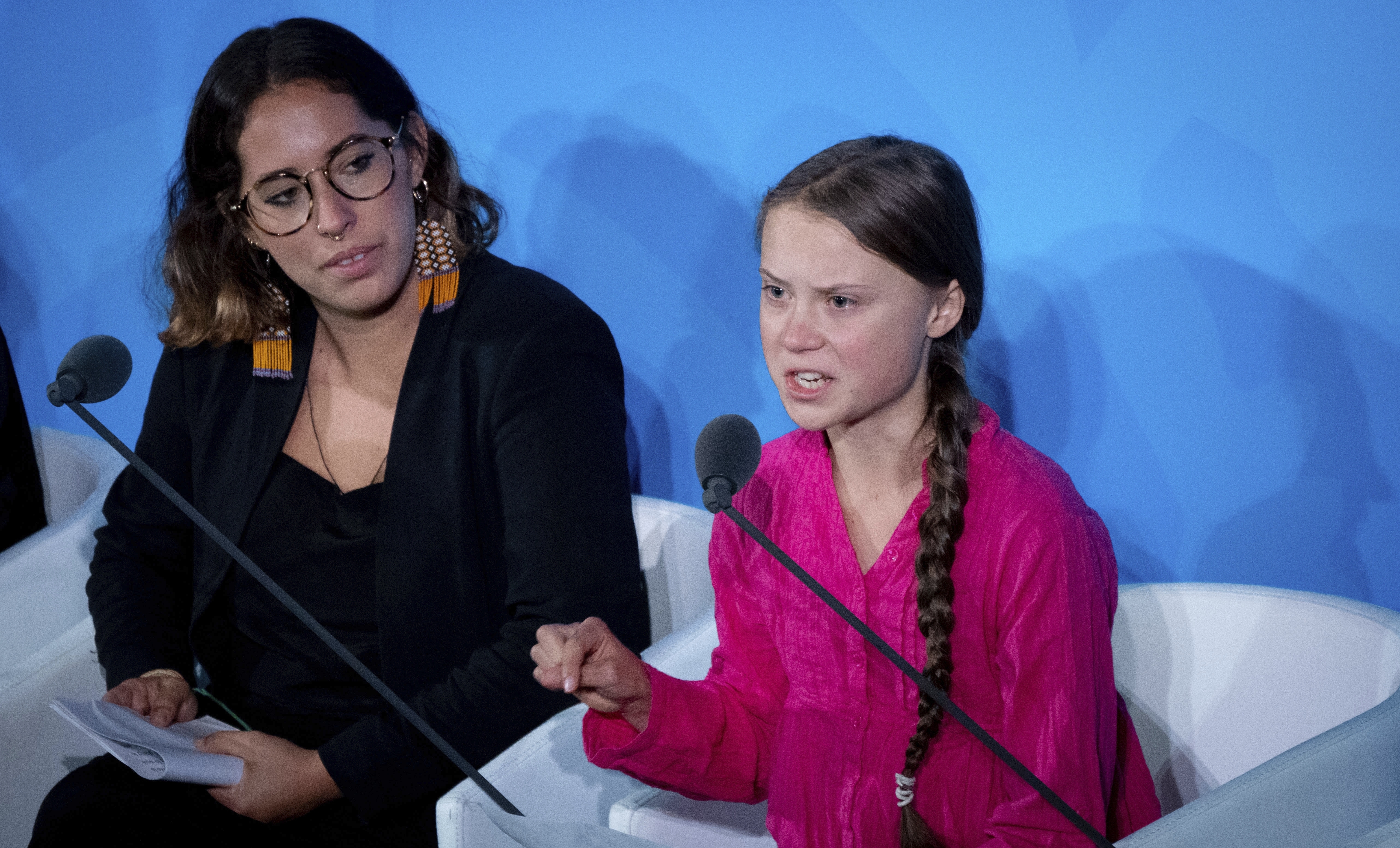 dpatop - 23 September 2019, US, New York: Climate activist Greta Thunberg (r) speaks at the United Nations Climate Change Conference. The United Nations expects more than 60 heads of state and government to present concrete, new plans to reduce CO2 emissions in short speeches lasting a maximum of three minutes. On the left is the Brazilian climate activist Paloma Costa. Photo by: Kay Nietfeld/picture-alliance/dpa/AP Images