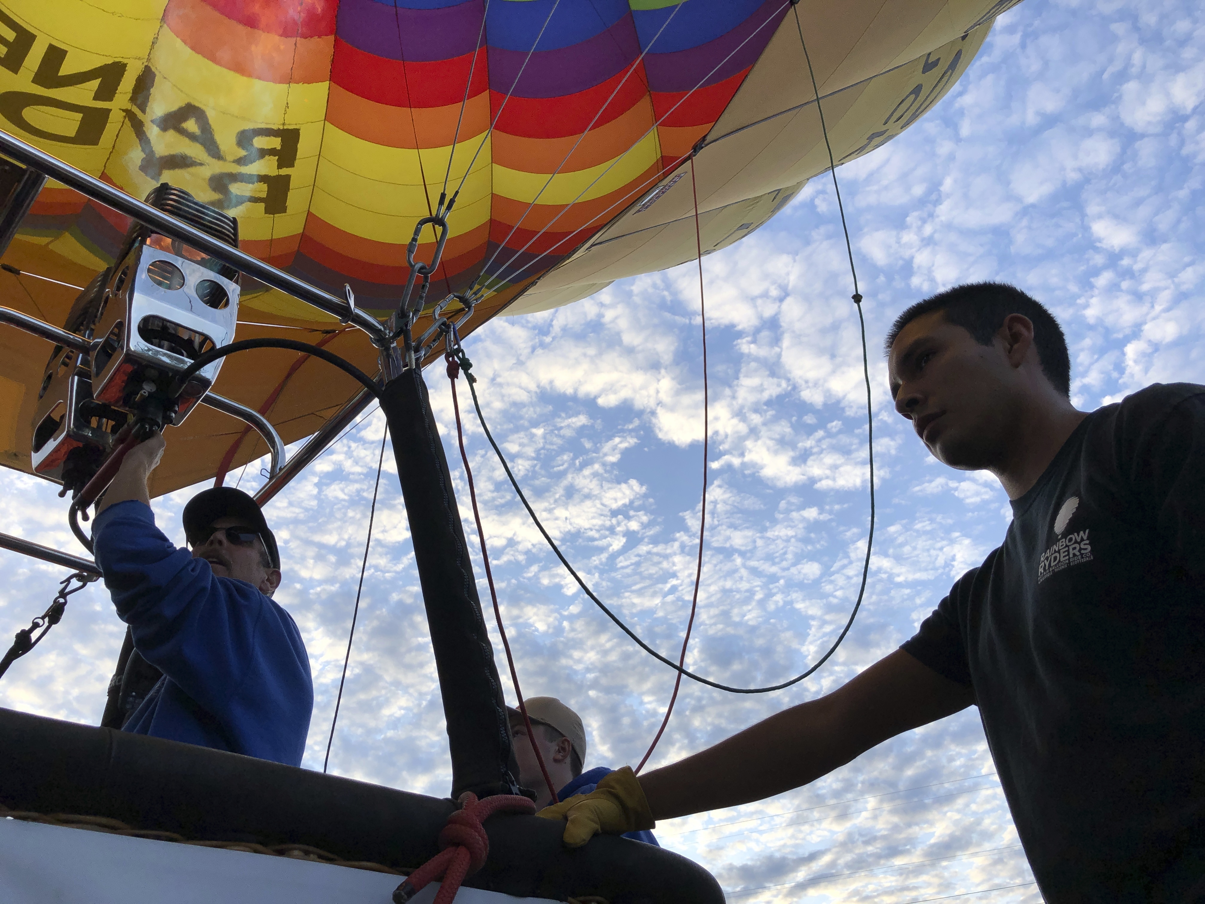 Elijah Sanchez, right, helps pilot Troy Bradley, left, prepare for liftoff in Albuquerque, N.M., on Tuesday, Oct. 1, 2019. Sanchez, 20, will be among the youngest pilots to launch as part of this year's Albuquerque International Balloon Fiesta. The nine-day event is expected to draw several hundred thousand spectators and hundreds of balloonists from around the world. It will kick off Oct. 5 with a mass ascension. (AP Photo/Susan Montoya Bryan)