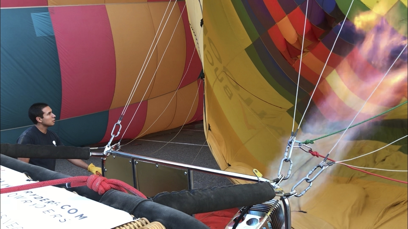 Elijah Sanchez helps inflate a hot air balloon in Albuquerque, N.M., on Tuesday, Oct. 1, 2019. Sanchez, 20, will be among the youngest pilots to launch as part of this year's Albuquerque International Balloon Fiesta. The nine-day event is expected to draw several hundred thousand spectators and hundreds of balloonists from around the world. It will kick off Oct. 5 with a mass ascension. (AP Photo/Susan Montoya Bryan)