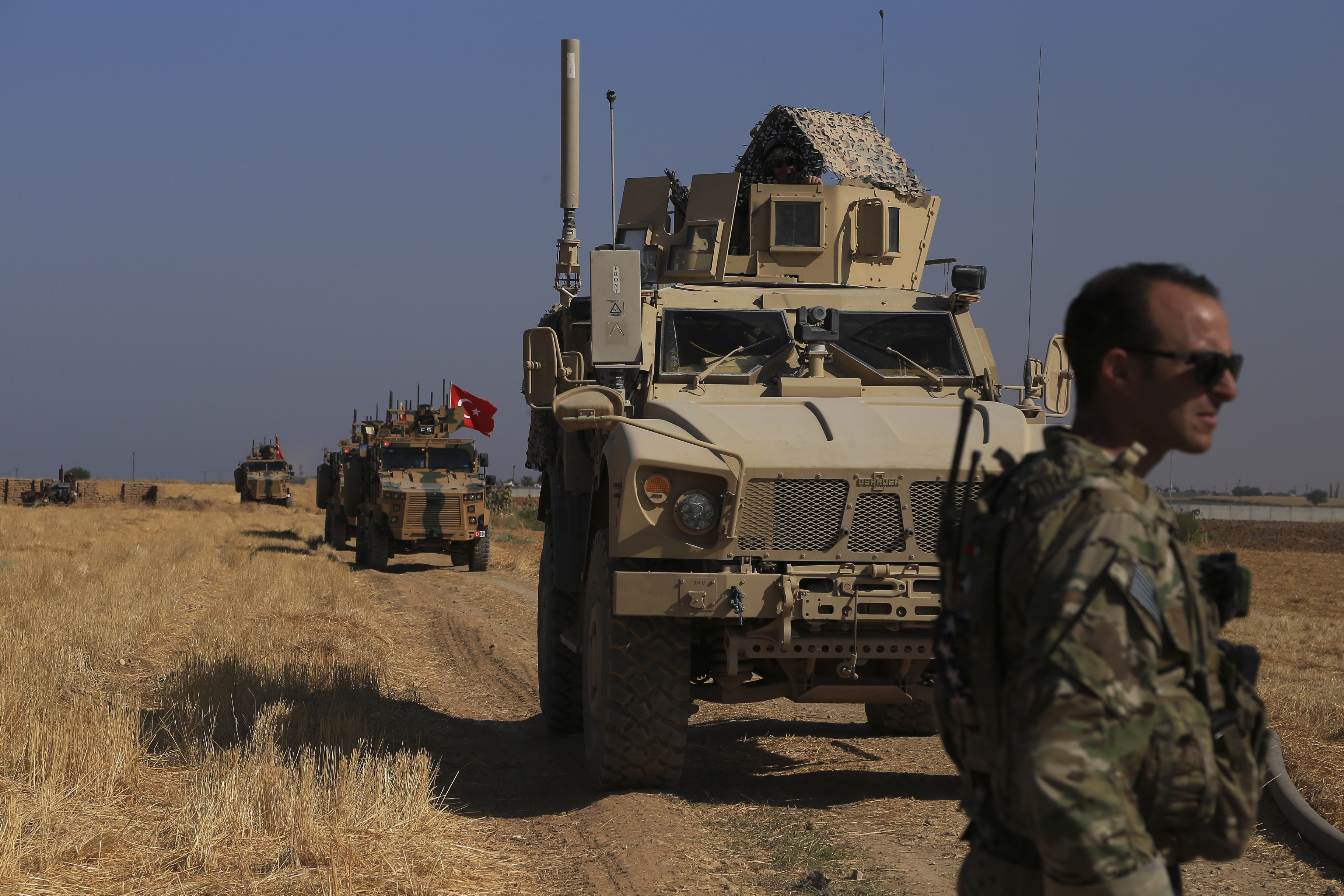 Turkish and American armored vehicles patrol as they conduct joint ground patrol in the so-called 