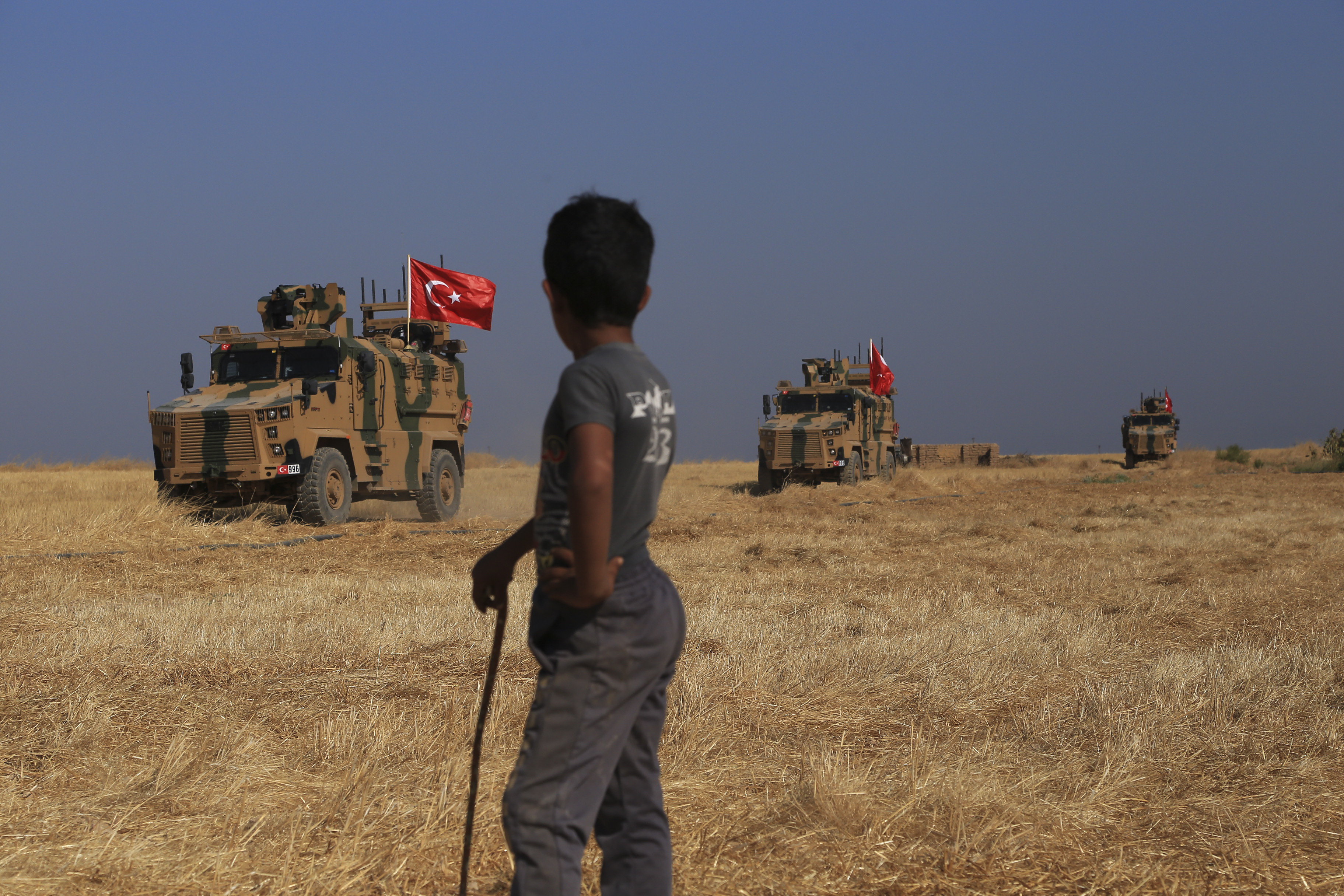 A Turkish n armored vehicles patrol as they conduct a joint ground patrol with American forces in the so-called 