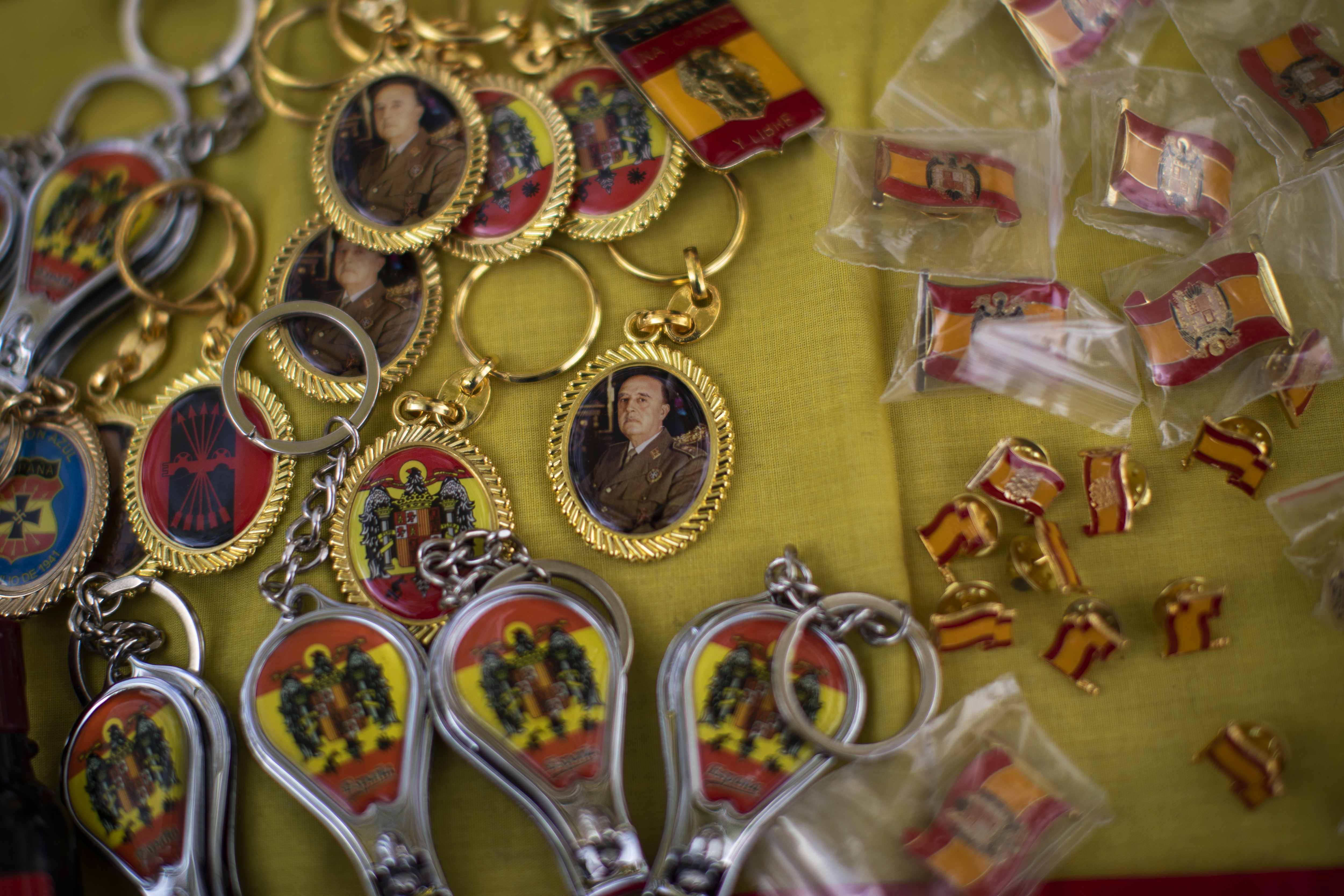 Key rings with photos of former Spanish dictator Francisco Franco are displayed for sale in a street stall during an alternative celebration for Spain's National Day in Barcelona, Spain, Saturday, Oct. 12, 2019. Spain commemorates Christopher Columbus' arrival in the New World and also Spain's armed forces day. (AP Photo/Emilio Morenatti)