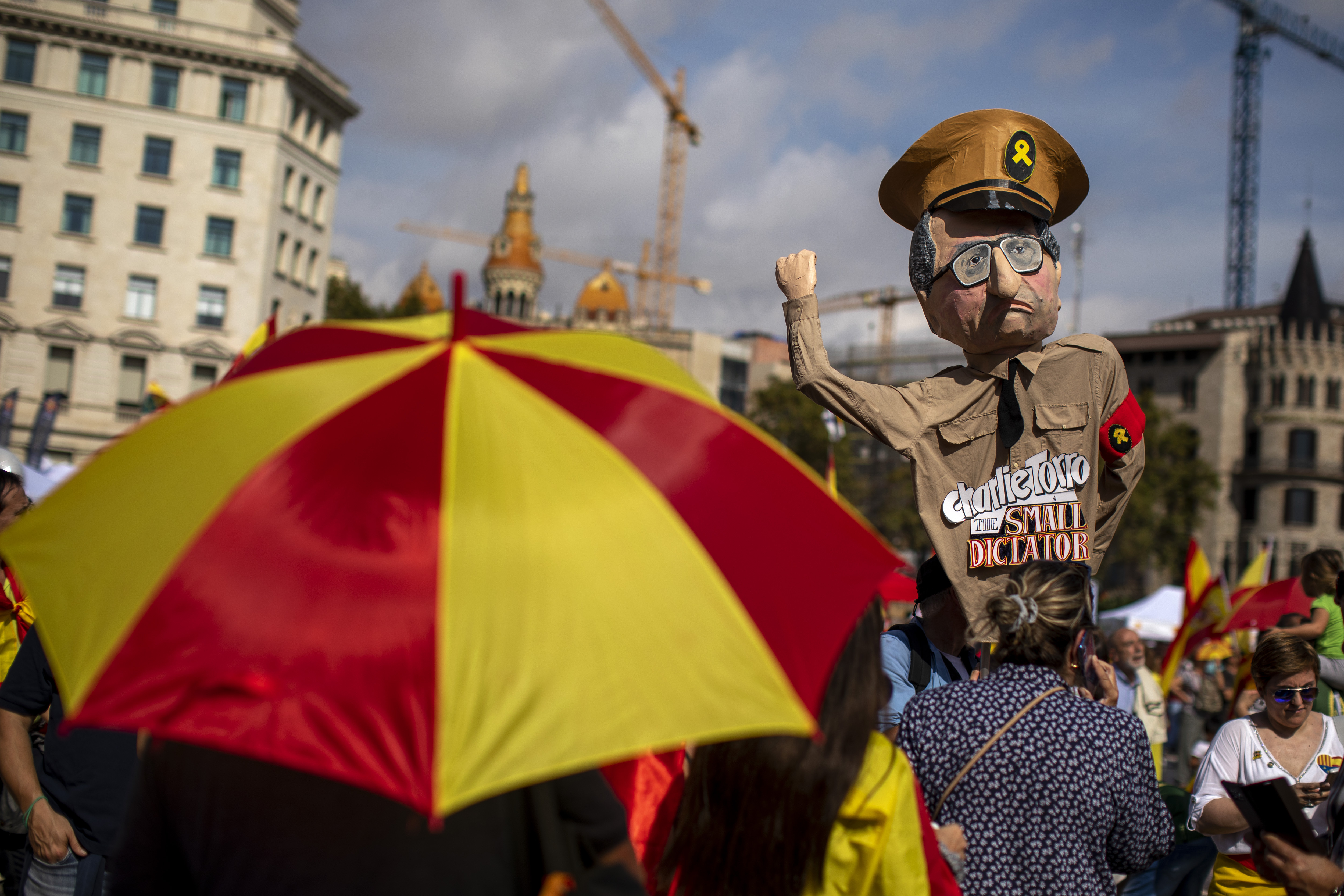 A demonstrator holds a paper doll representing regional Catalan President Quim Torra, as they celebrate a holiday known as 