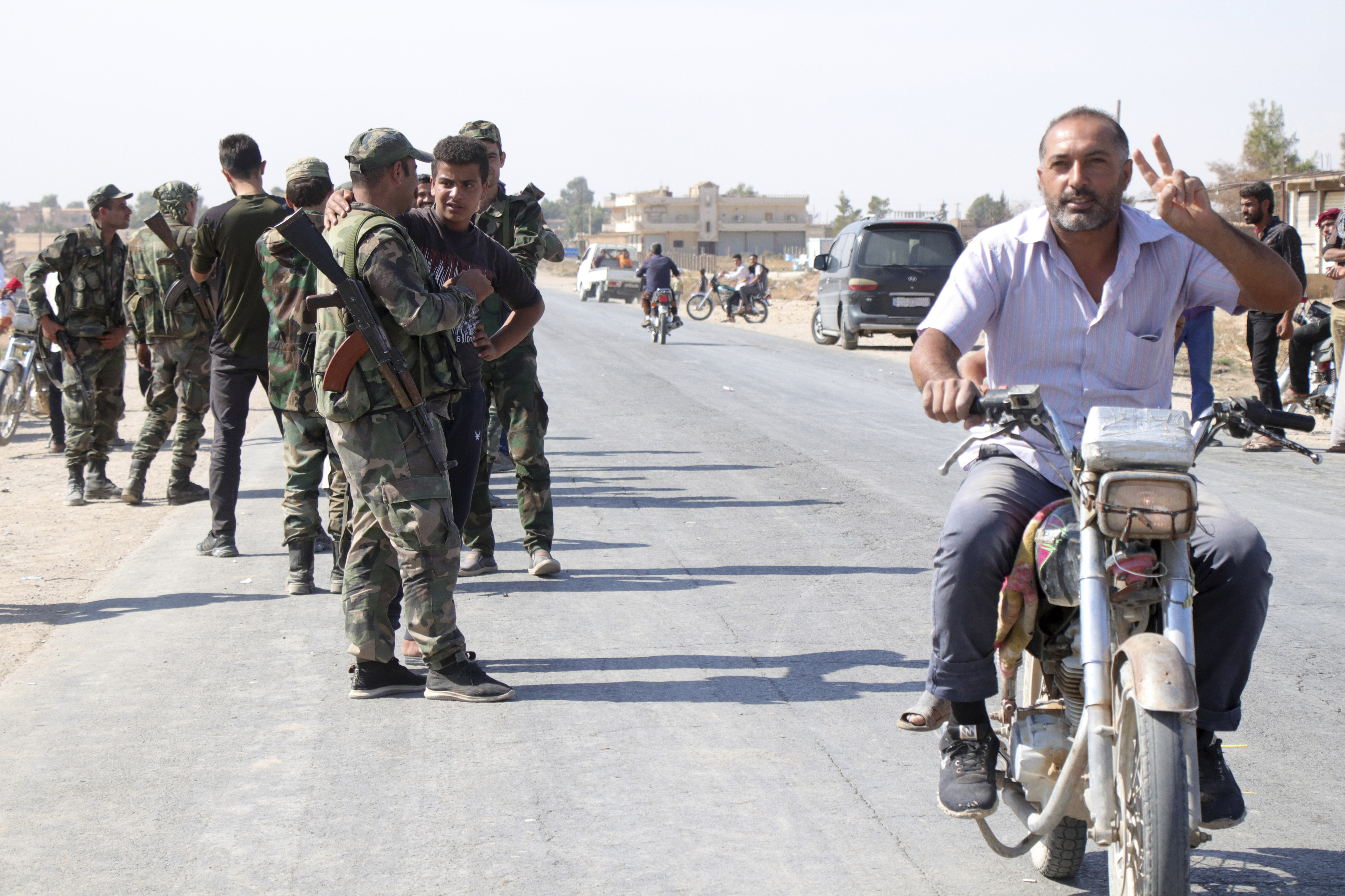 Syrian troops deploy in the village of Ghebesh, west of the town of Tal Tamr, in northern Syria, Monday, Oct 14, 2019. Syrian government troops moved into towns and villages in northern Syria on Monday, setting up a potential clash with Turkish-led forces advancing in the area as long-standing alliances in the region begin to crumble following the pullback of U.S. forces. (AP Photo)