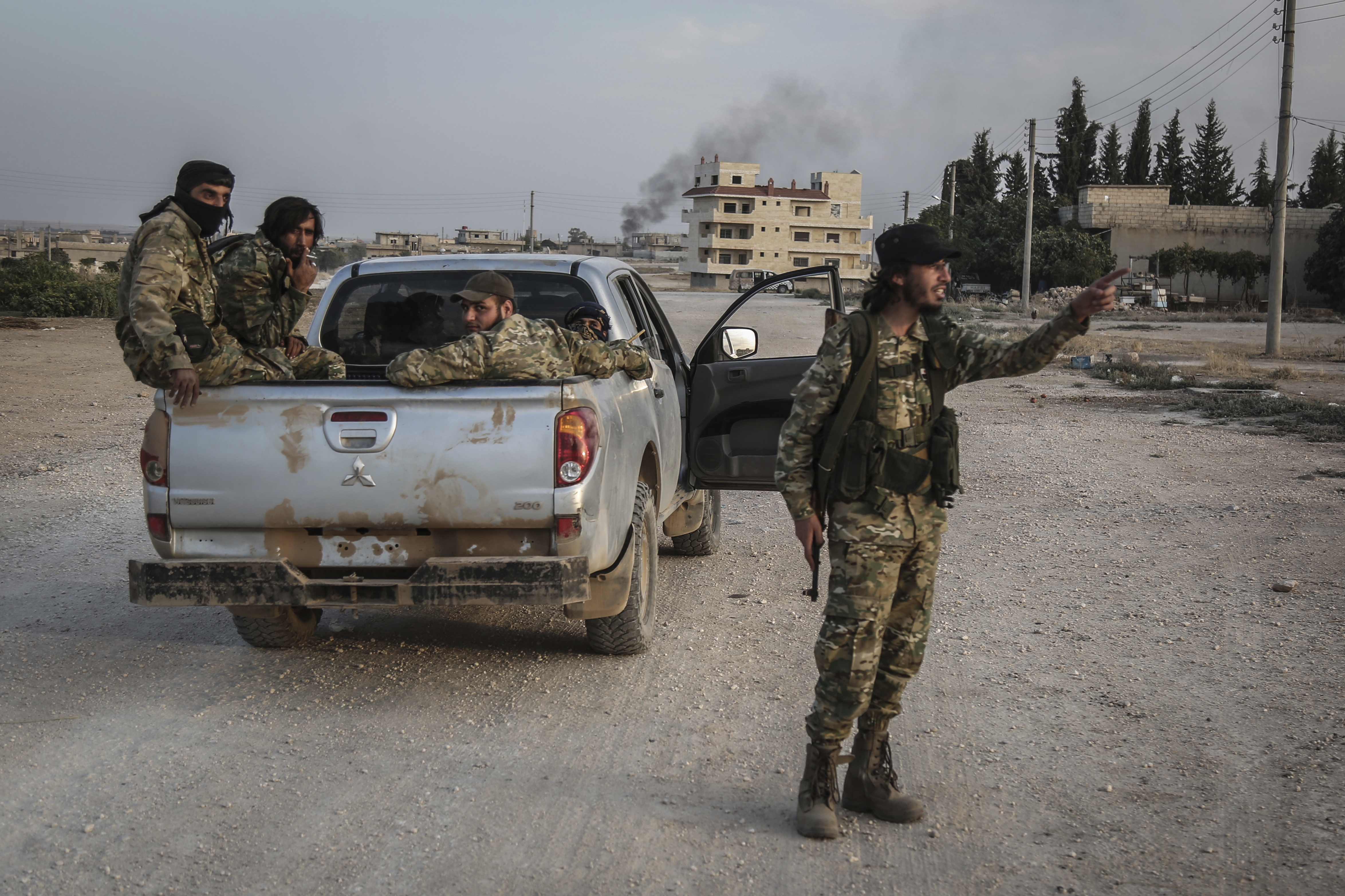 14 October 2019, Syria, Tell Abiad: Soldiers of the Turkish-backed Syrian National Army patrol a street after clashes with Kurdish fighters. Photo by: Anas Alkharboutli/picture-alliance/dpa/AP Images