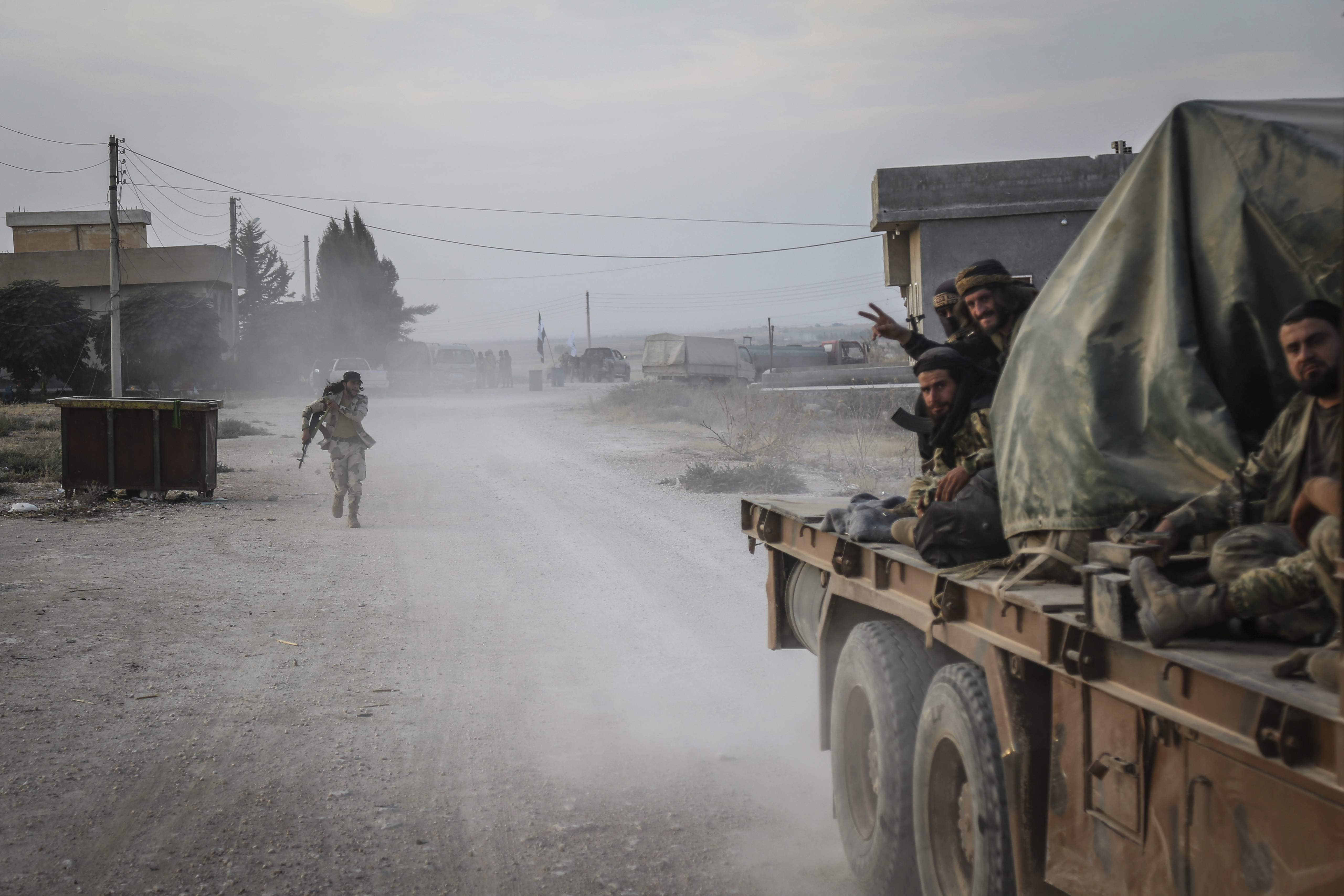 14 October 2019, Syria, Tell Abiad: Soldiers of the Turkish-backed Syrian National Army gesture after clashes with Kurdish fighters. Photo by: Anas Alkharboutli/picture-alliance/dpa/AP Images