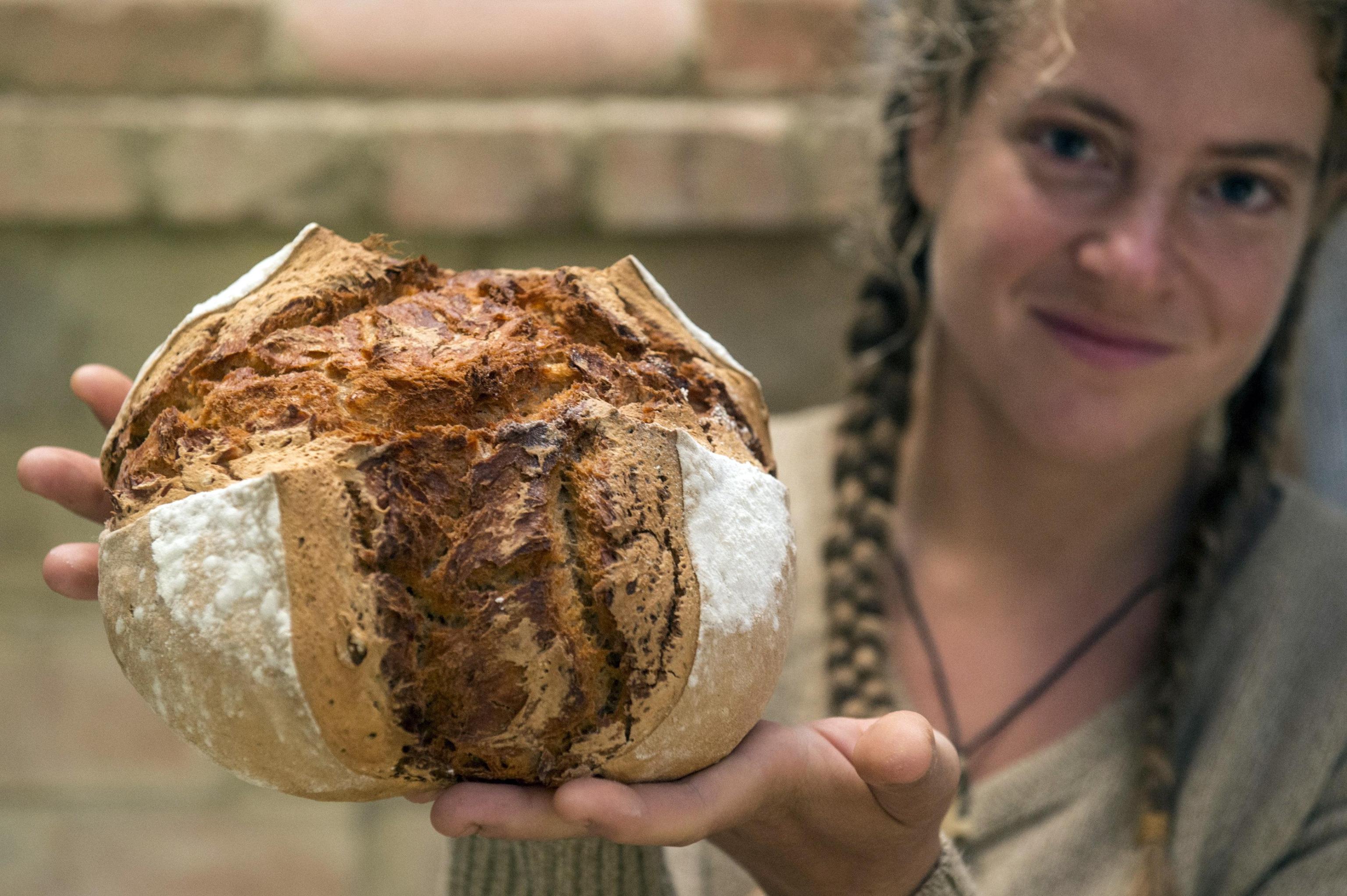 epa07924762 Hungarian organic gardener Dominika Zaka holds a freshly baked bread in her hands at their place of residence, in a yurt in Szentes, Hungary, 16 October 2019. The young woman and her partner bake leavened bread made of organic flours for themselves and their friends once a week. World Bread Day is celebrated on 16 October to commemorate the anniversary of the creation of the Food and Agriculture Organization of the United Nations (FAO).  EPA/Sandor Ujvari HUNGARY OUT ATTENTION: This Image is part of a PHOTO SET