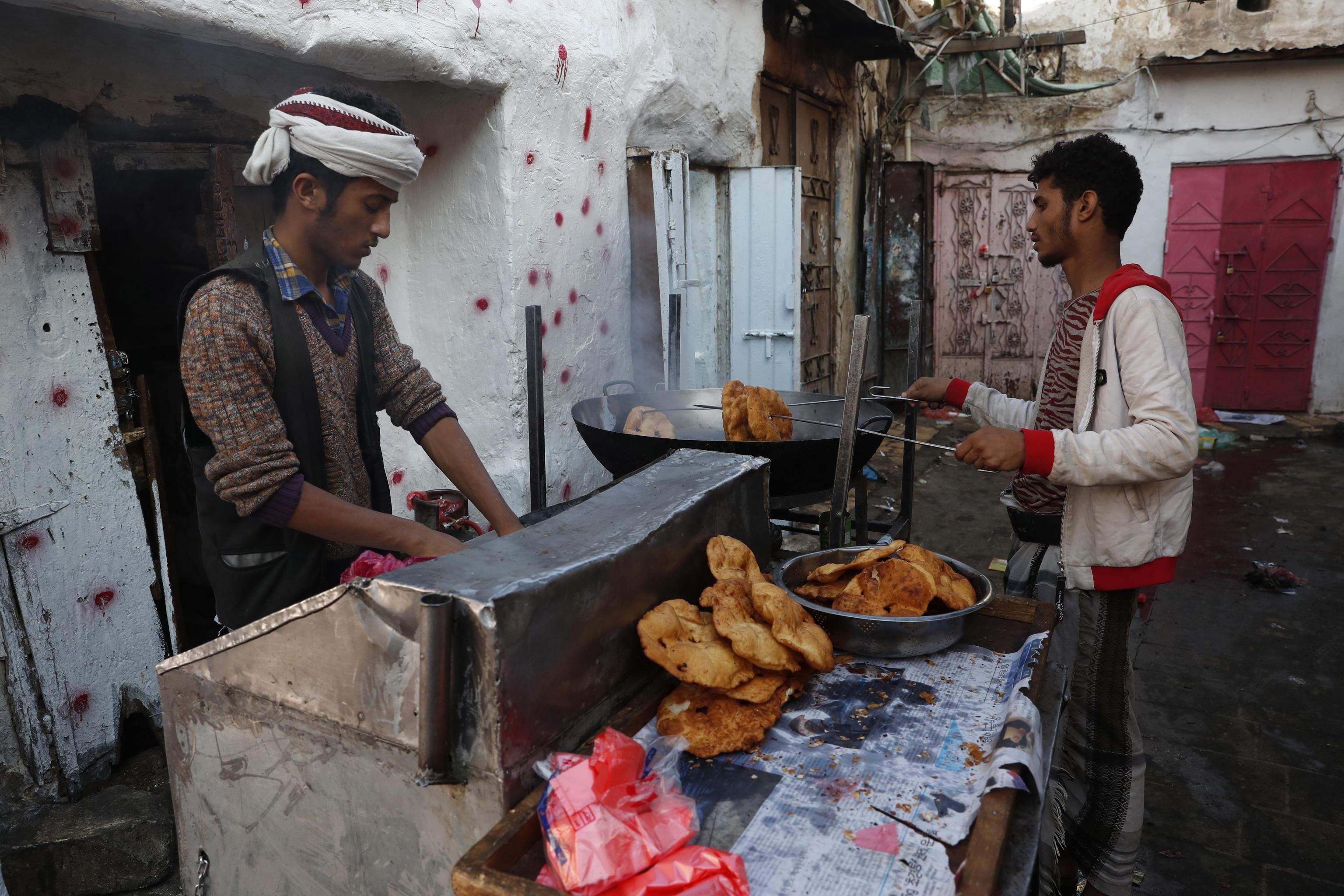 epa07929506 A man prepares bread for sale at a market in the old quarter of Sanaâa, Yemen, 18 October 2019. Yemen has been in a state of political crisis since the 2011-street protests, culminating in the outbreak of a fighting in March 2015 when the Saudi-led military coalition launched a massive air campaign against the Houthi rebel group, which overran much of the Arab country.  EPA/YAHYA ARHAB