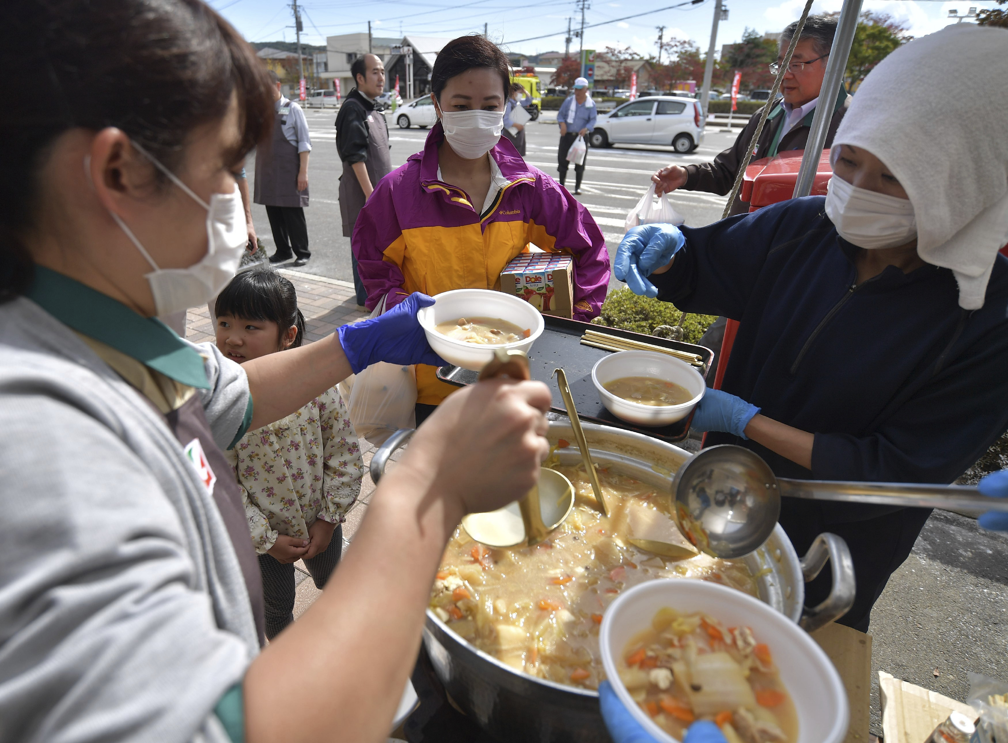 Disaster victims receive food in Motomiya, Fukushima prefecture on Oct. 20, 2019. Typhoon Hagibis, a powerful super typhoon, made a landfall in Japan on Oct. 12th, and caused huge damage in wide area of Japan. 80 were killed and 11 are still missing as of 19th 5pm. ( The Yomiuri Shimbun via AP Images )
