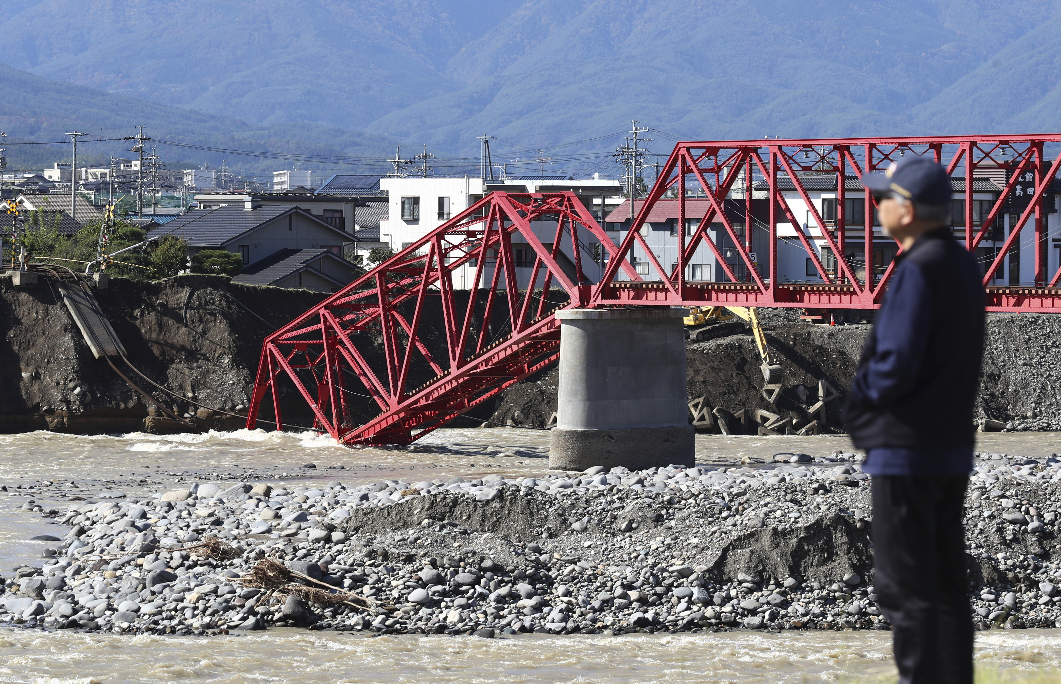 A bridge of Ueda Electric Railway Bessho Line damaged by the flooding of Chikuma River triggered by the typhoon Hagibis is pictured in Ueda, Nagano prefecture on Oct. 23, 2019. The powerful Typhoon Hagibis landed on Japan on Oc. 12, bringing about a record rainfall, overflow of rivers and landslides. 82 people have been confirmed dead. ( The Yomiuri Shimbun via AP Images )