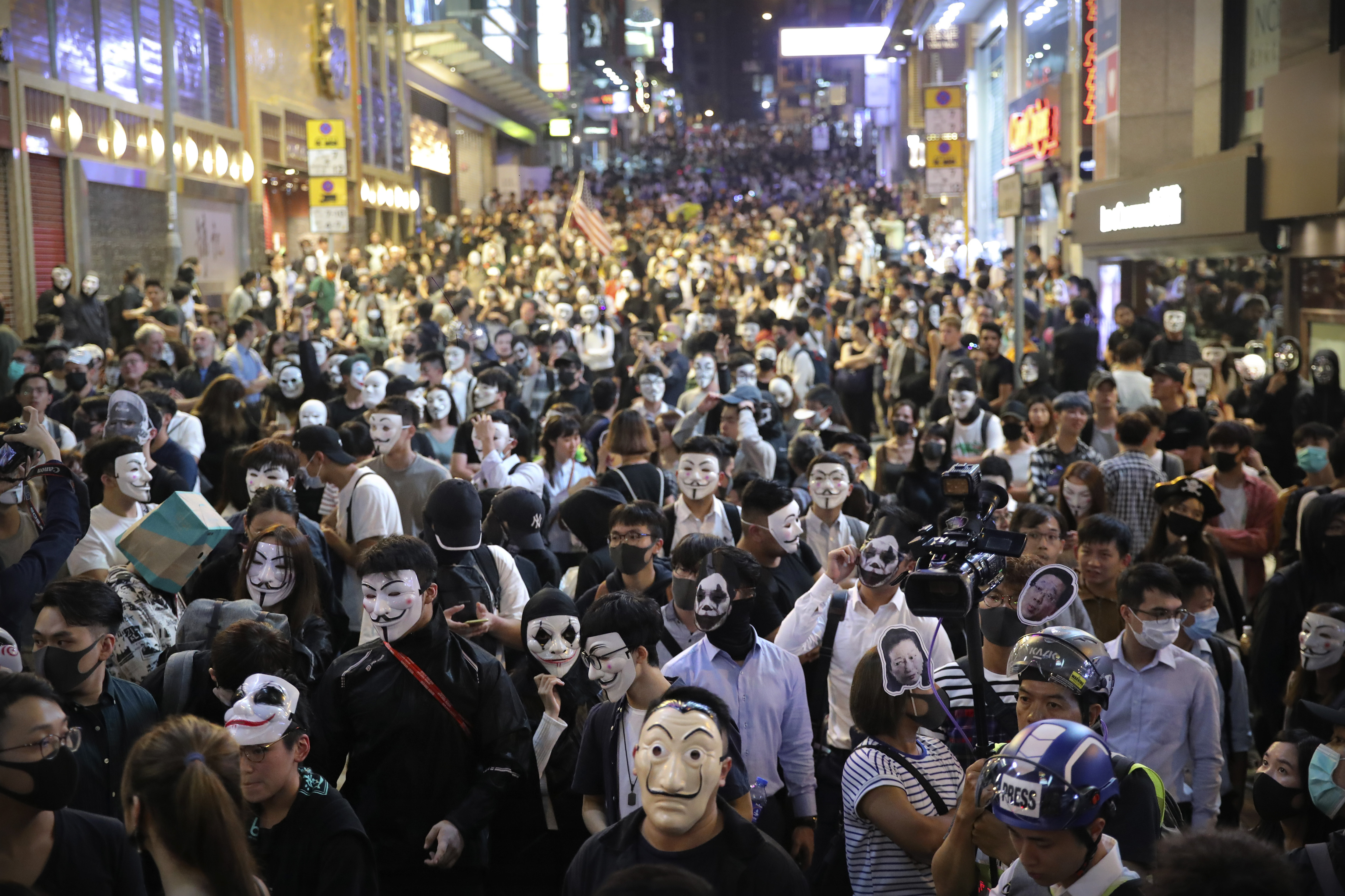 People wearing masks gather on a street in Hong Kong, Thursday, Oct. 31, 2019. Hong Kong authorities are bracing as pro-democracy protesters urged people on Thursday to celebrate Halloween by wearing masks on a march in defiance of a government ban on face coverings. (AP Photo/Kin Cheung)