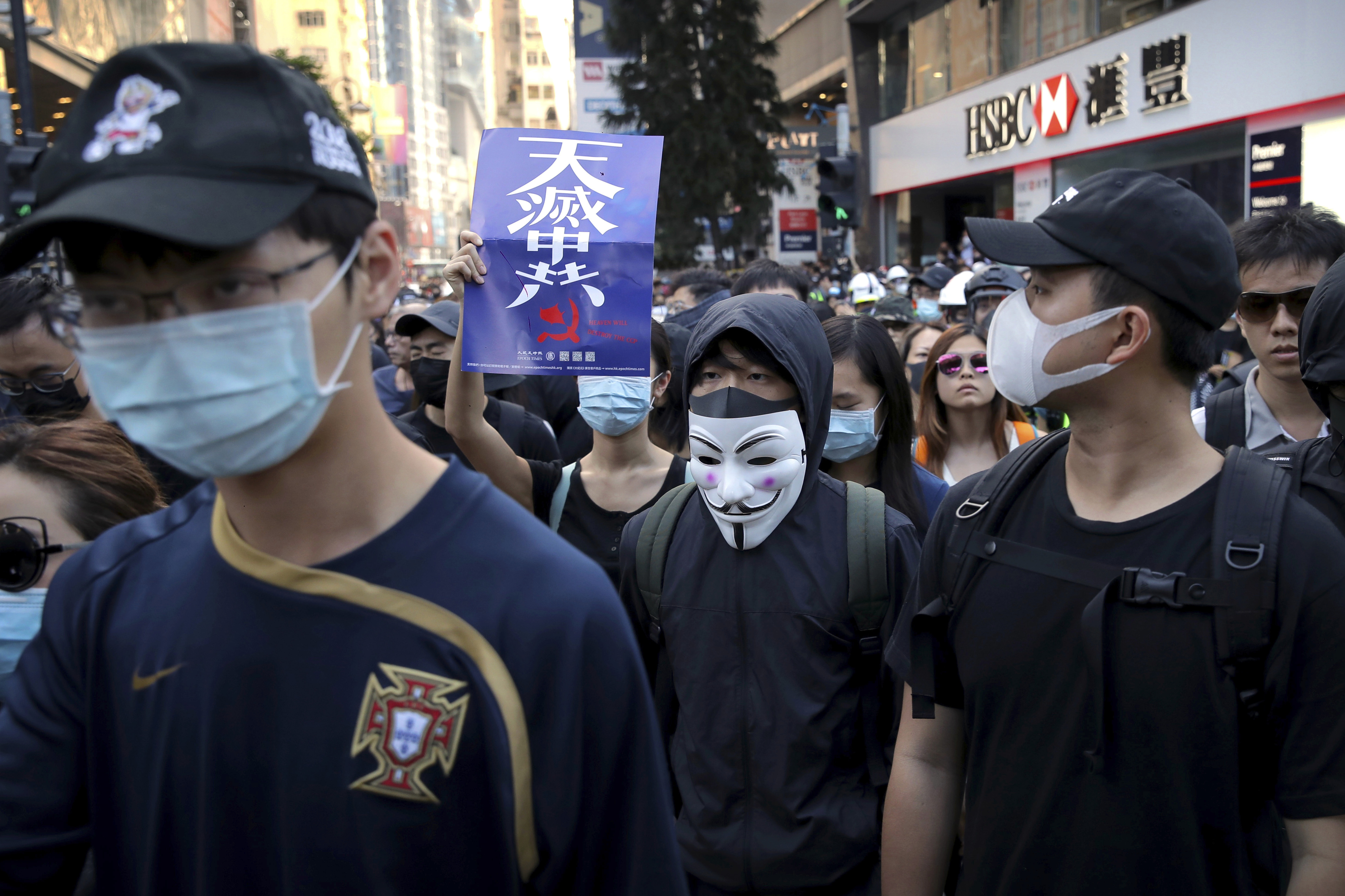 Demonstrators wearing masks gather during an anti-government protest in Hong Kong, Saturday, Nov. 2, 2019. Defying a police ban, thousands of black-clad masked protesters are streaming into Hong Kong's central shopping district for another rally demanding autonomy in the Chinese territory as Beijing indicated it could tighten its grip. (AP Photo/Kin Cheung)