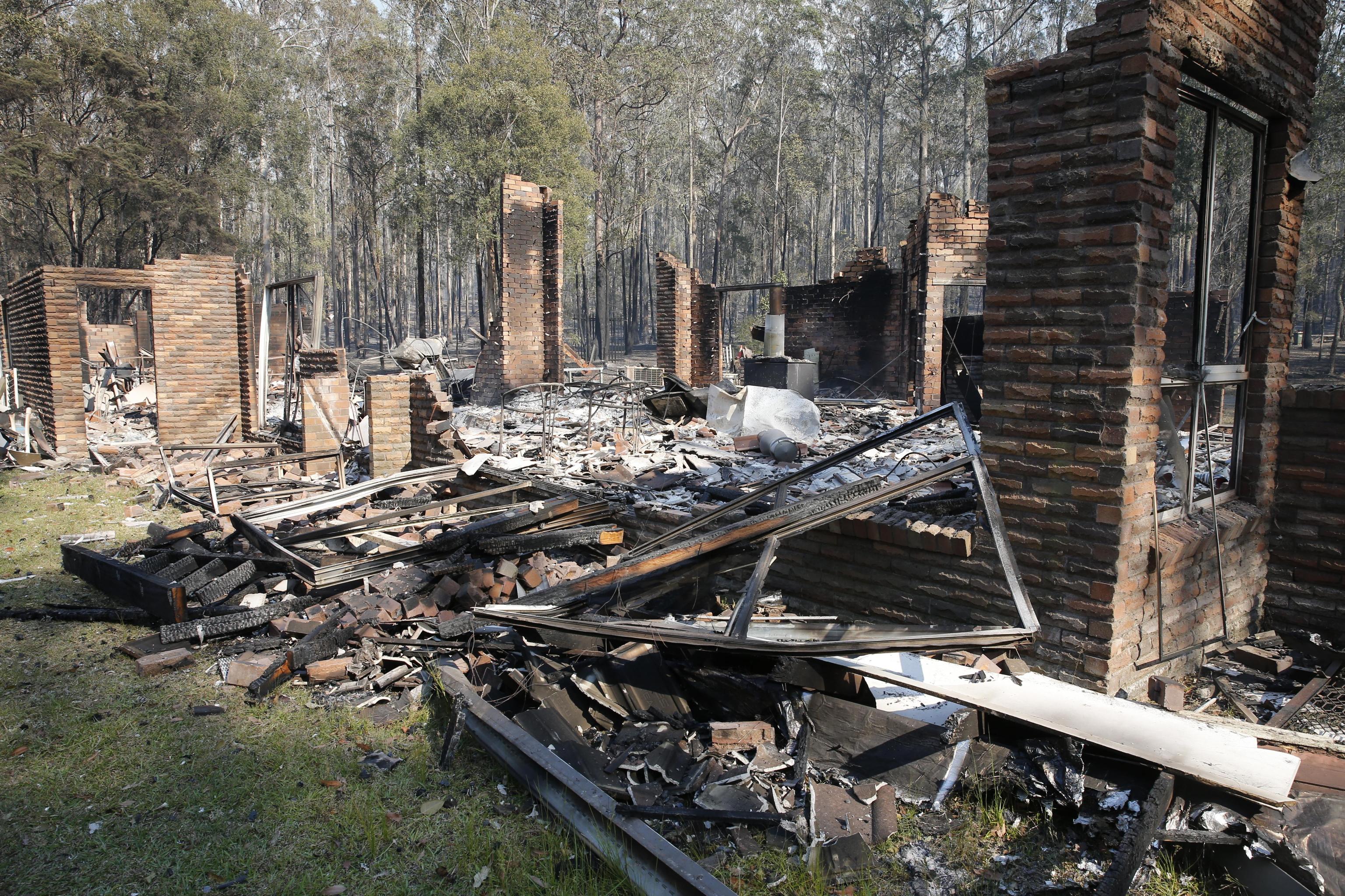 epa07982438 The remains of the residence at Four Paws boarding kennels smoulders along the Pacific Highway south of Taree, New South Wales, Australia, 09 November 2019. Two people have been killed and seven others are msising due to bushfires in New South Wales, which have also destroyed at least 100 homes.  EPA/DARREN PATEMAN AUSTRALIA AND NEW ZEALAND OUT