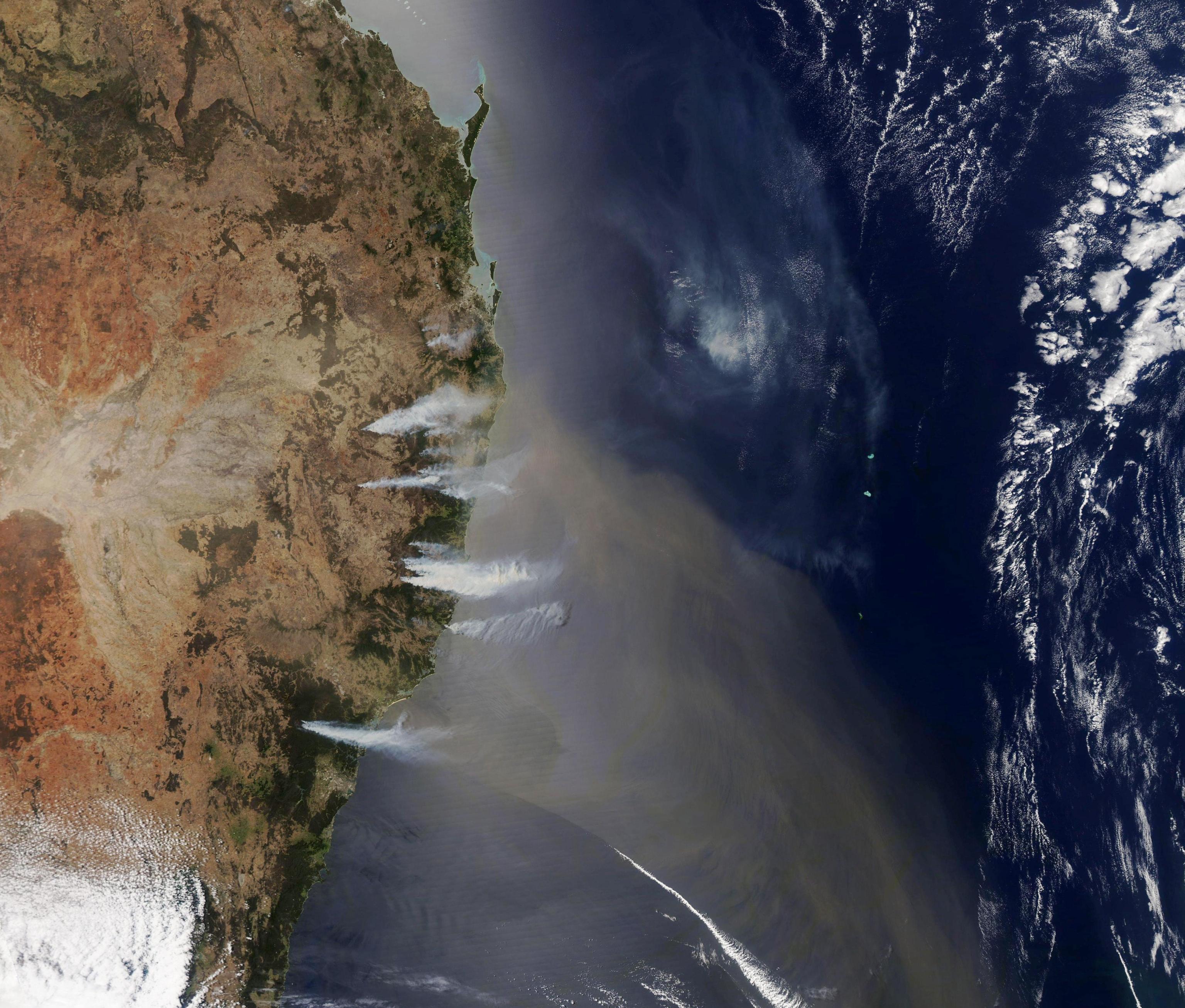 epa07981601 A handout photo made available by NASA Earth Observatory shows a satellite image of destructive bushfires raging near the coast of New South Wales, Australia, 07 November 2019 (issued 08 November 2019), sending smoke billowing over the Tasman Sea. Fires that day burned from north of Sydney to near the border with Queensland. According to the New South Wales Rural Fire Service, 29 of the 69 fires burning across the state remained uncontrolled.  EPA/NASA EARTH OBSERVATORY HANDOUT  HANDOUT EDITORIAL USE ONLY/NO SALES