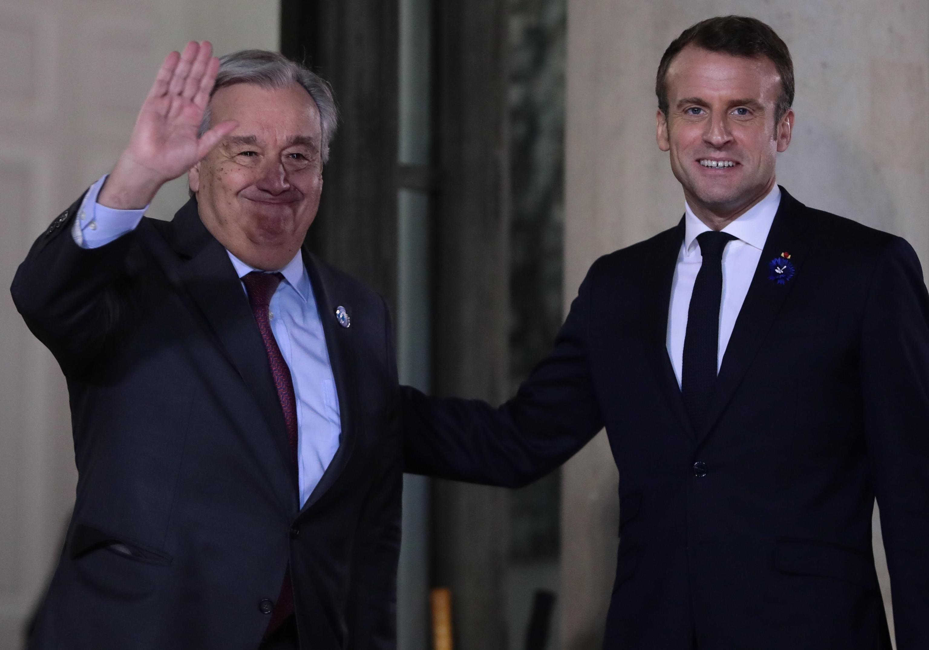 epa07989128 President Emmanuel Macron (R) greets UN Secretary-General Antonio Guterres (L) for a dinner with participants of the Paris Peace Forum, at the Elysee Palace, in Paris, France, 11 November 2019.  EPA/CHRISTOPHE PETIT TESSON
