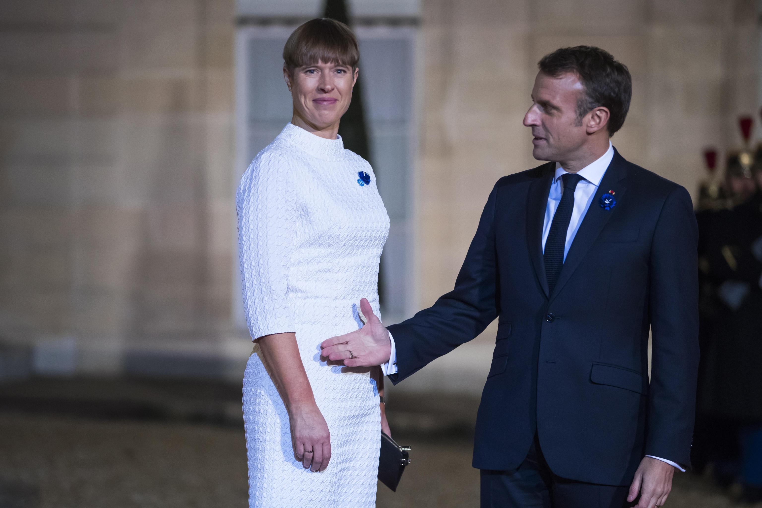 epa07989435 French President Emmanuel Macron (R) welcomes Estonian president Kersti Kaljulaid (L) for a dinner held with participants of the Paris Peace Forum, at the Elysee Palace, in Paris, France, 11 November 2019.  EPA/CHRISTOPHE PETIT TESSON