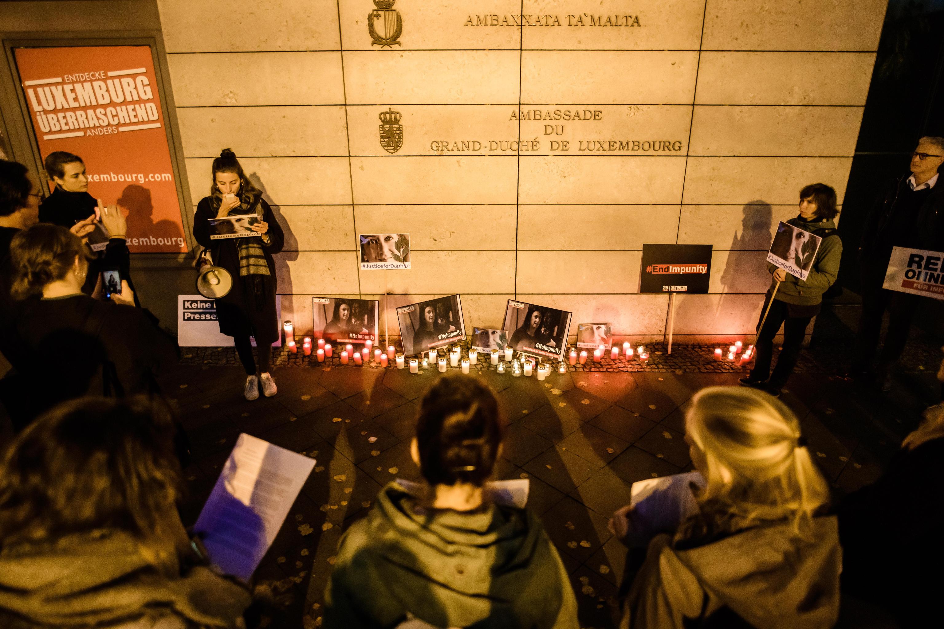 epa07925853 People stand together during a picket in front of the Maltese embassy for murdered journalist Daphne Caruana Galizia in Berlin, Germany, 16 October 2019. Reporters Without Borders organized a picket for murdered journalist Daphne Caruana Galizia, who was killed on 16 October 2017 in Malta, while investigating the Panama Papers case.  EPA/CLEMENS BILAN