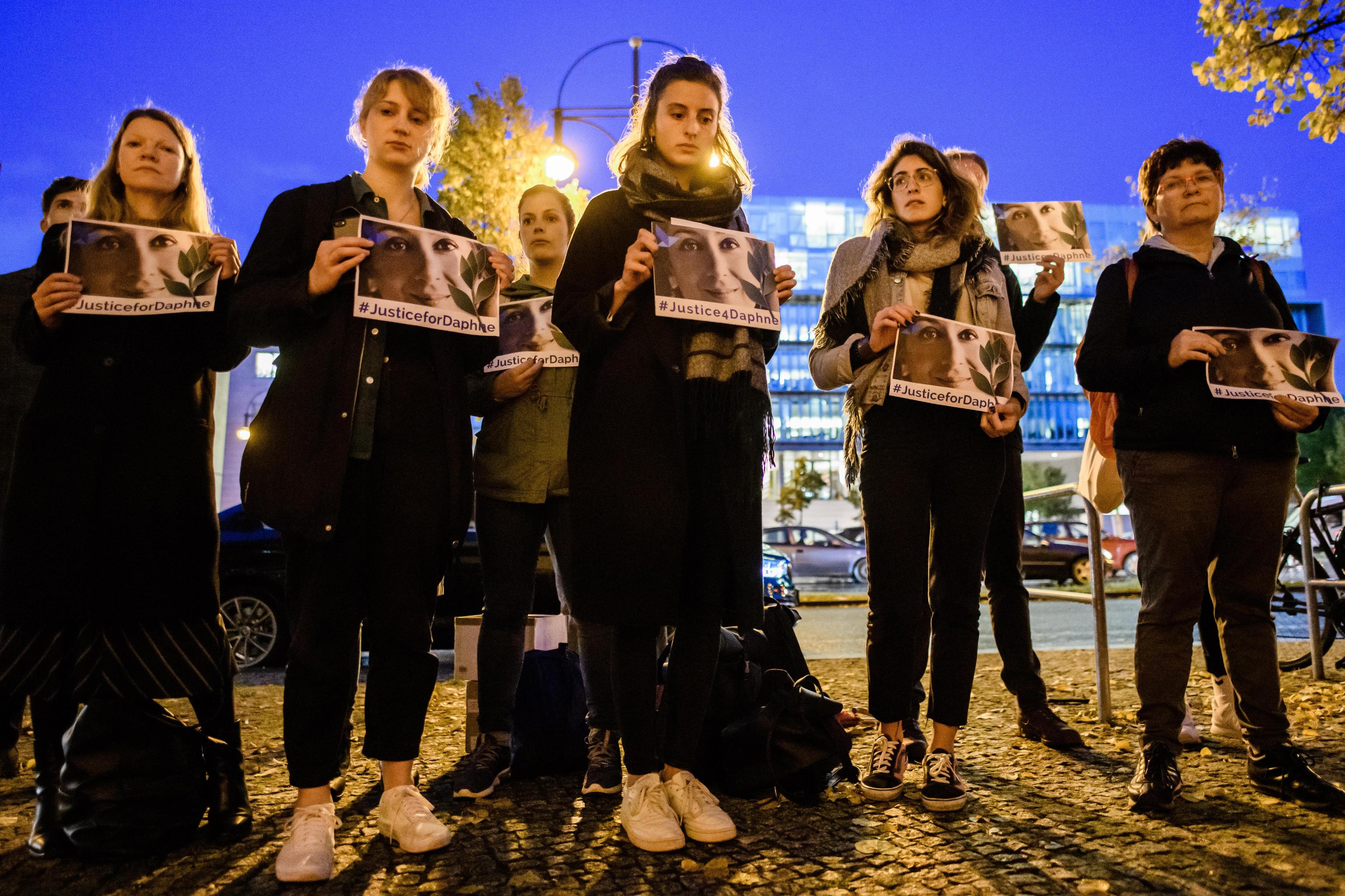 epa07925852 People stand together during a picket in front of the Maltese embassy for murdered journalist Daphne Caruana Galizia in Berlin, Germany, 16 October 2019. Reporters Without Borders organized a picket for murdered journalist Daphne Caruana Galizia, who was killed on 16 October 2017 in Malta, while investigating the Panama Papers case.  EPA/CLEMENS BILAN