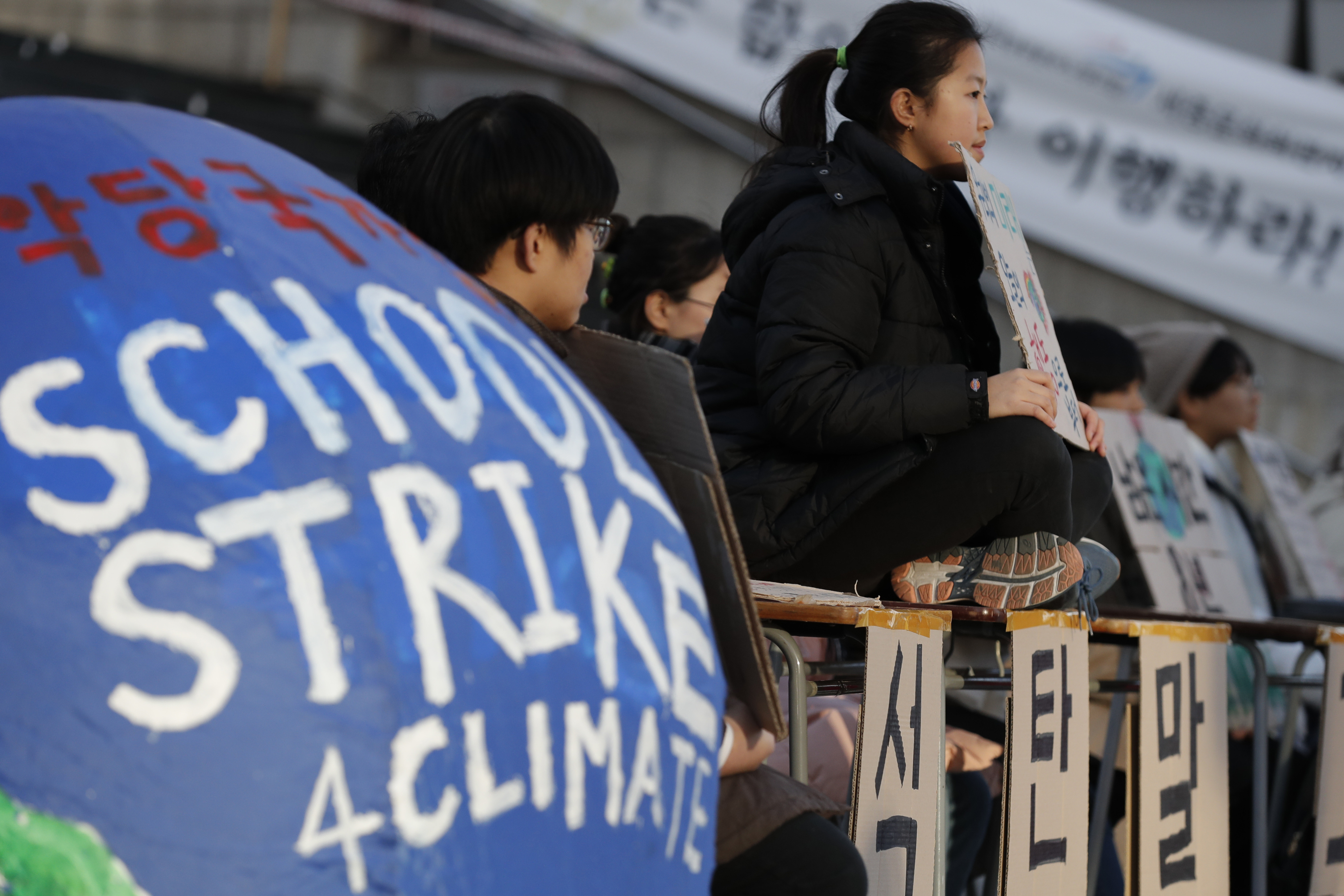 South Korean students hold banners during a rally for climate strike for future in Seoul, South Korea, Friday, Nov. 29, 2019. More than 10 students attended the rally demanding their government to take sufficient action against climate change. (AP Photo/Lee Jin-man)