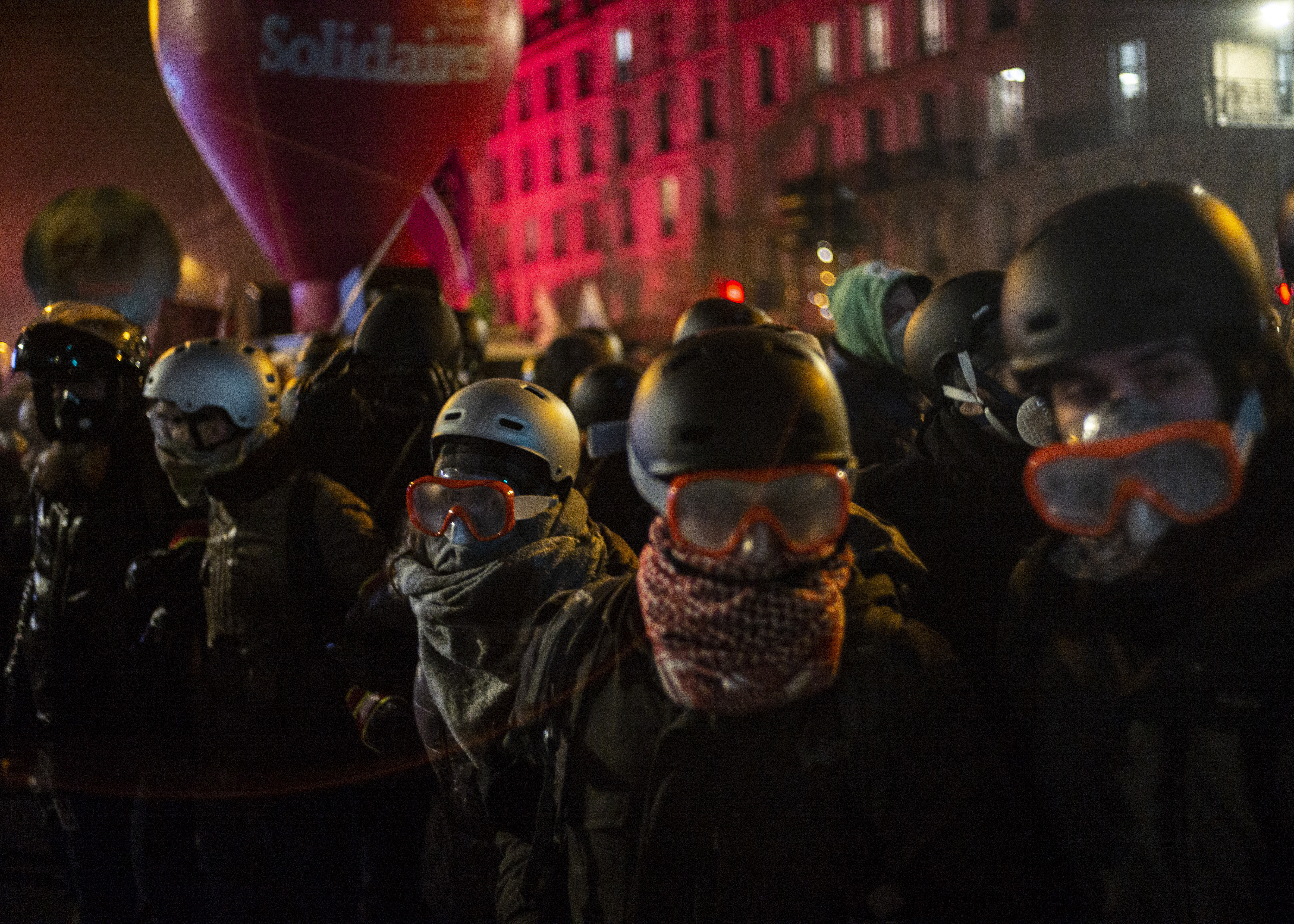 Protestors march during a demonstration in Paris, Thursday, Dec. 5, 2019. The Eiffel Tower shut down, France's high-speed trains stood still and tens of thousands of people marched through Paris and other cities Thursday, in a massive and sometimes chaotic outpouring of anger at the government's plan to overhaul the retirement system. (AP Photo/Rafael Yaghobzadeh)