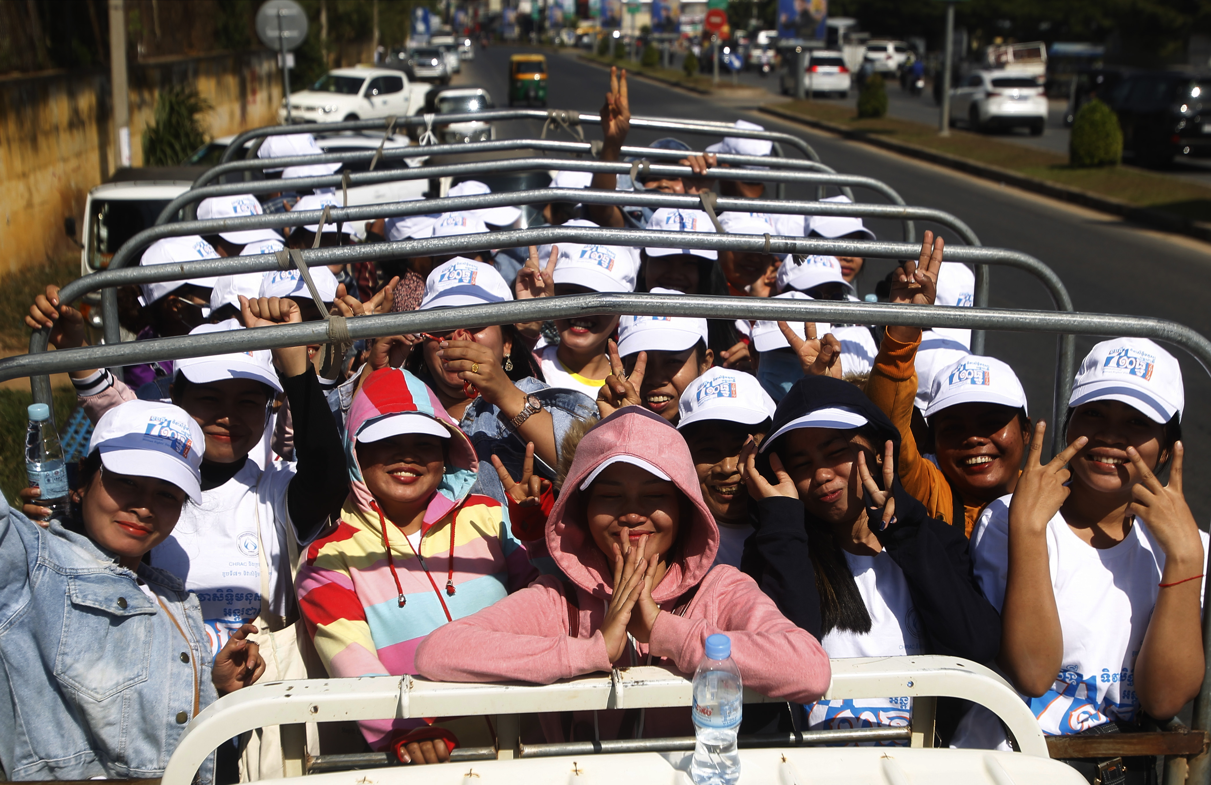 Cambodian factory workers stand on a truck after they participate in a celebration to mark the Human Rights Day at Democracy Square in Phnom Penh, Cambodia, Tuesday, Dec. 10, 2019. The United Nation's adopted Dec. 10 as the international human rights day in 1948 and has been observed annually ever since. (AP Photo/Heng Sinith)