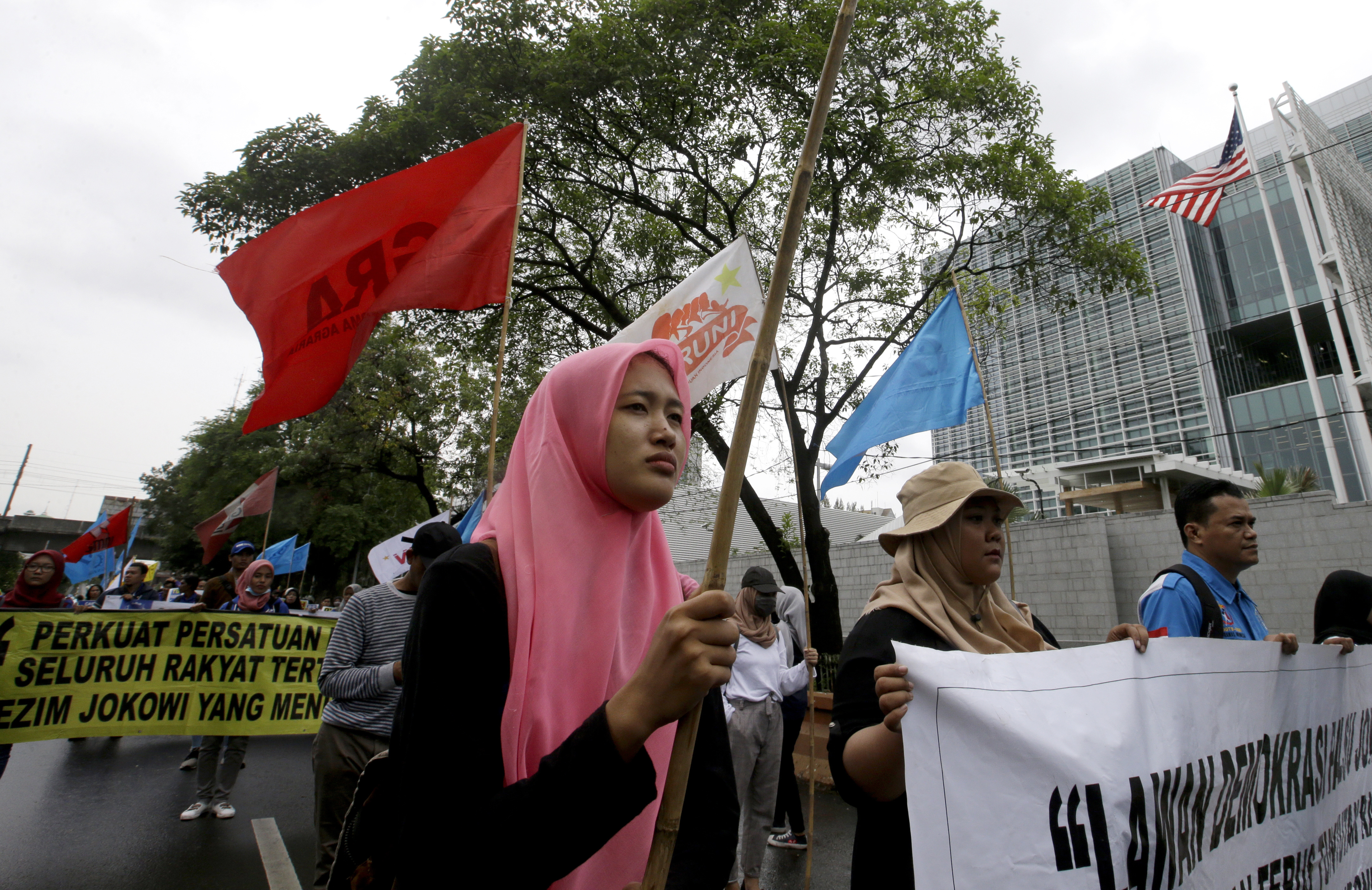Activists march during rally to mark the Human Rights Day outside U.S. embassy in Jakarta, Indonesia, Tuesday, Dec. 10, 2019. Rights activists marched in Indonesia's capital Tuesday, calling on the government of the world's most populous Muslim and third largest democracy to protect and respect human rights.(AP Photo/Achmad Ibrahim)