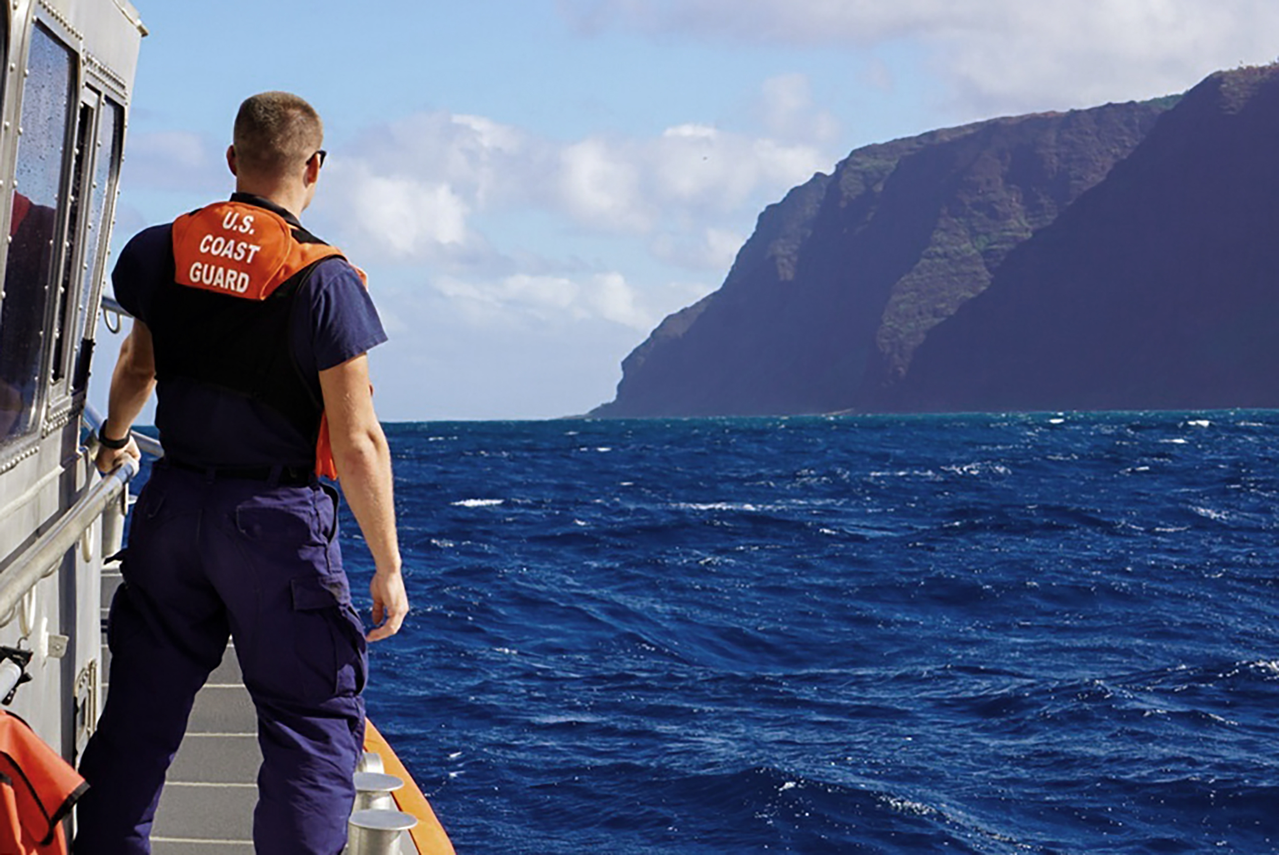 In this photo released by the U.S. Coast Guard, Coast Guard Cutter William Hart moves toward the Na Pali Coast on the Hawaiian island of Kauai on Friday, Dec. 27, 2019, the day after a tour helicopter disappeared with seven people aboard. Authorities say wreckage of the helicopter has been found in a mountainous area on the island. (Lt. j.g. Daniel Winter/U.S. Coast Guard via AP)