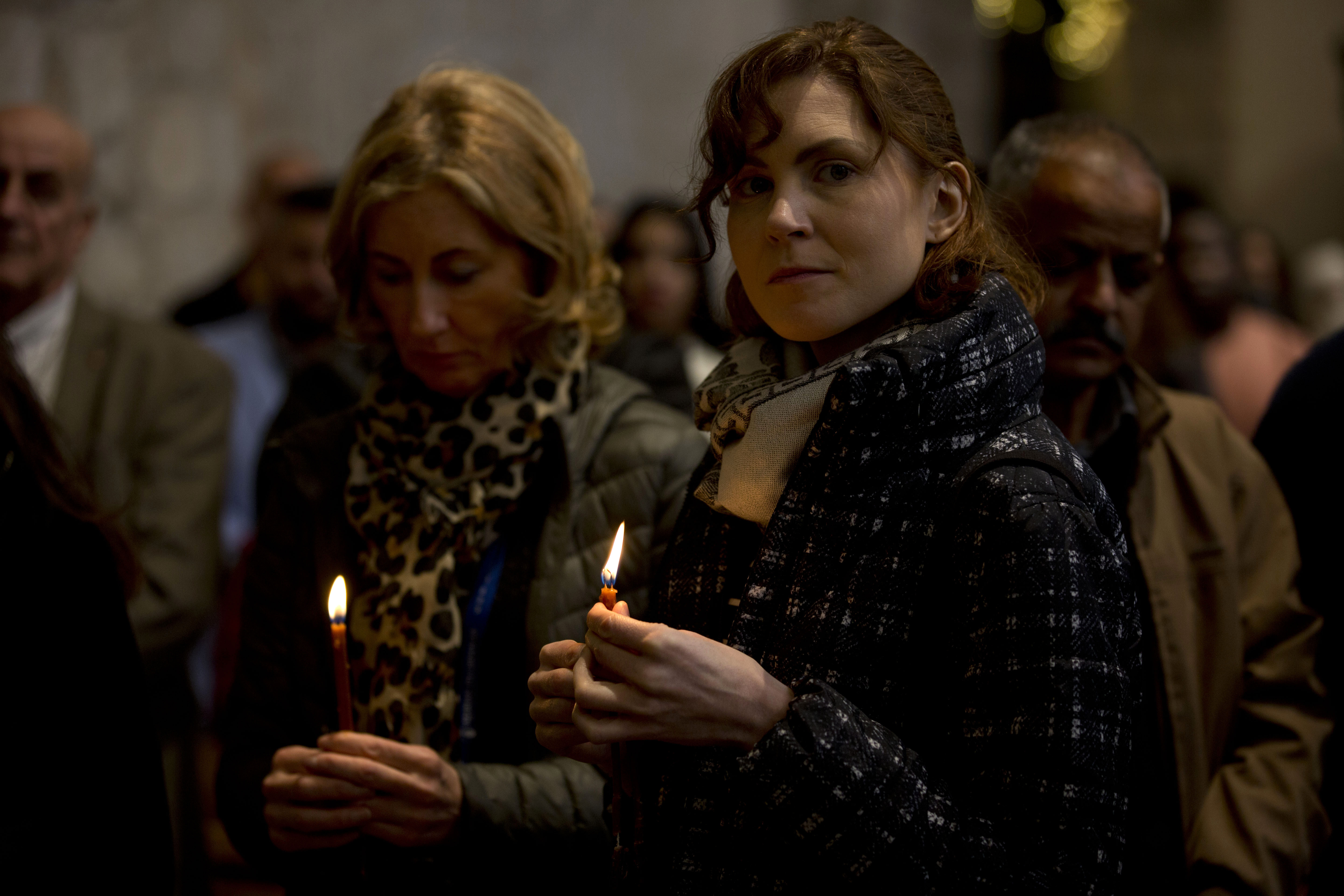 Worshiper hold candles and pray during a Christmas day Mass at the Church of the Nativity, traditionally believed to be the birthplace of Jesus Christ, in the West Bank town of Bethlehem, Wednesday, Dec. 25, 2019. (AP Photo/Majdi Mohammed)