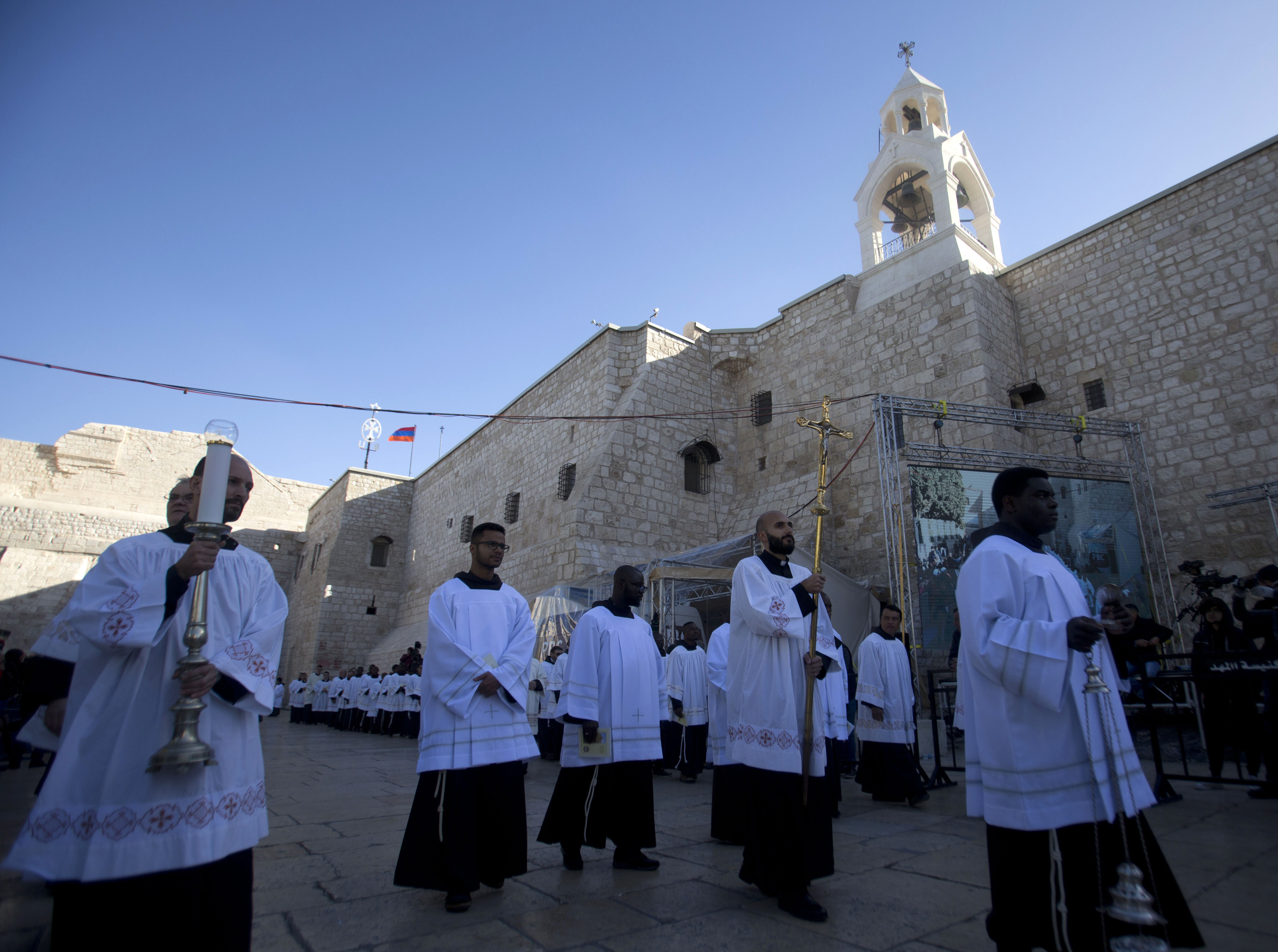 Clergymen participate in Christmas celebrations outside the Church of the Nativity, built atop the site where Christians believe Jesus Christ was born, on Christmas Eve, in the West Bank City of Bethlehem, Tuesday, Dec. 24, 2019. (AP Photo/Majdi Mohammed)