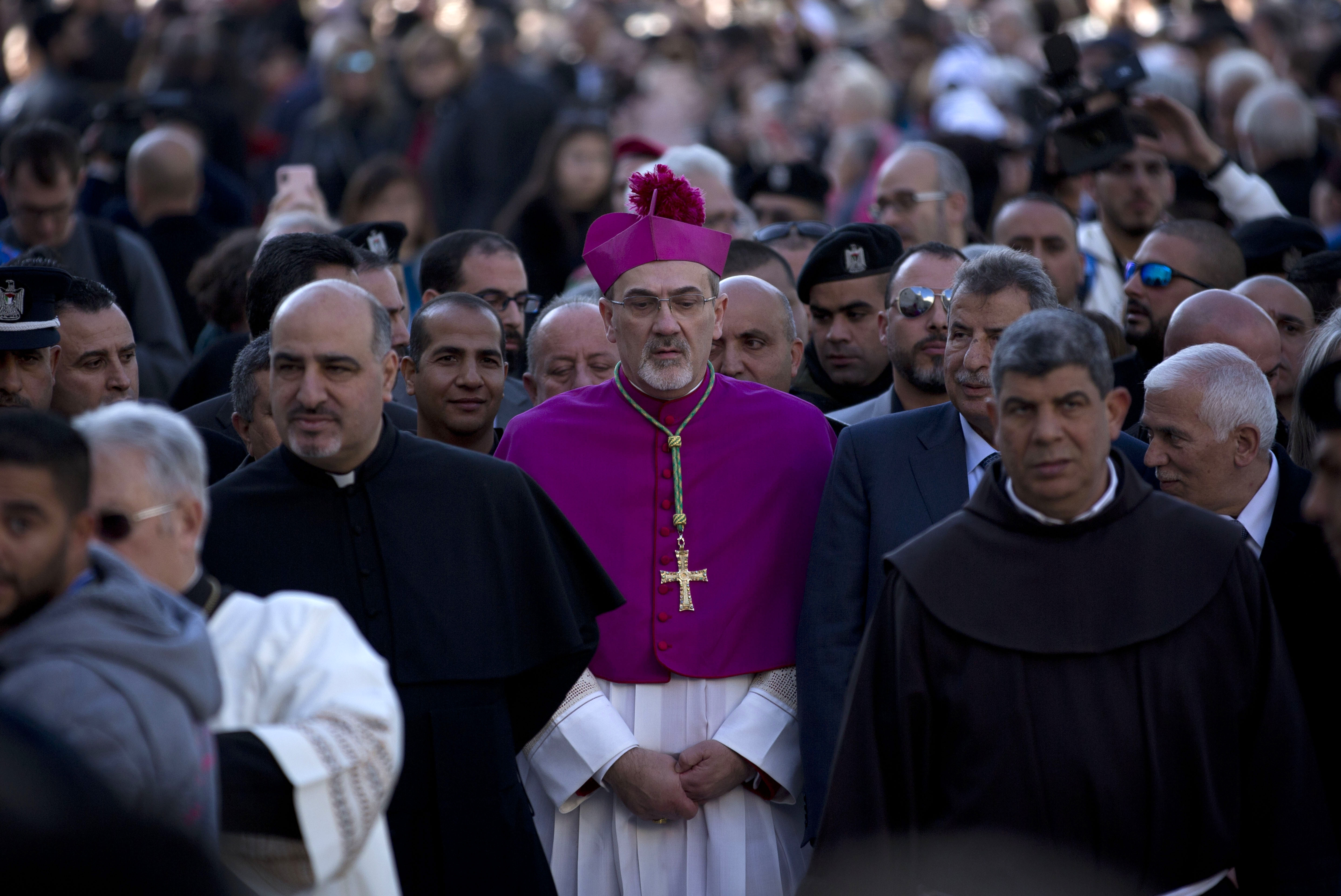 The Latin Patriarch of Jerusalem Pierbattista Pizzaballa arrives to the Church of the Nativity, built atop the site where Christians believe Jesus Christ was born, on Christmas Eve, in the West Bank City of Bethlehem, Tuesday, Dec. 24, 2019. (AP Photo/Majdi Mohammed)