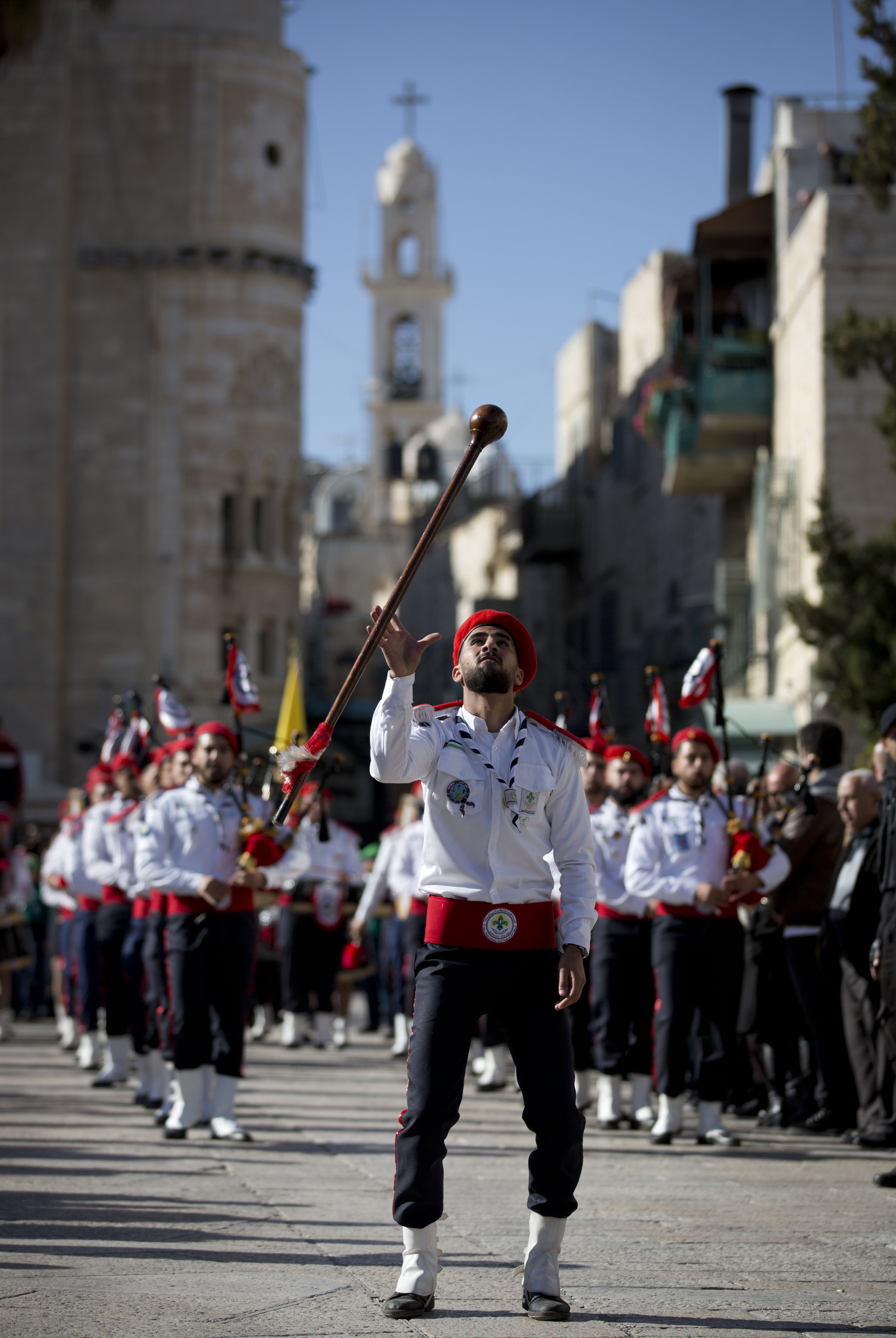 A Palestinian Scout marching band parade during Christmas celebrations outside the Church of the Nativity, built atop the site where Christians believe Jesus Christ was born, on Christmas Eve, in the West Bank City of Bethlehem, Tuesday, Dec. 24, 2019. (AP Photo/Majdi Mohammed)