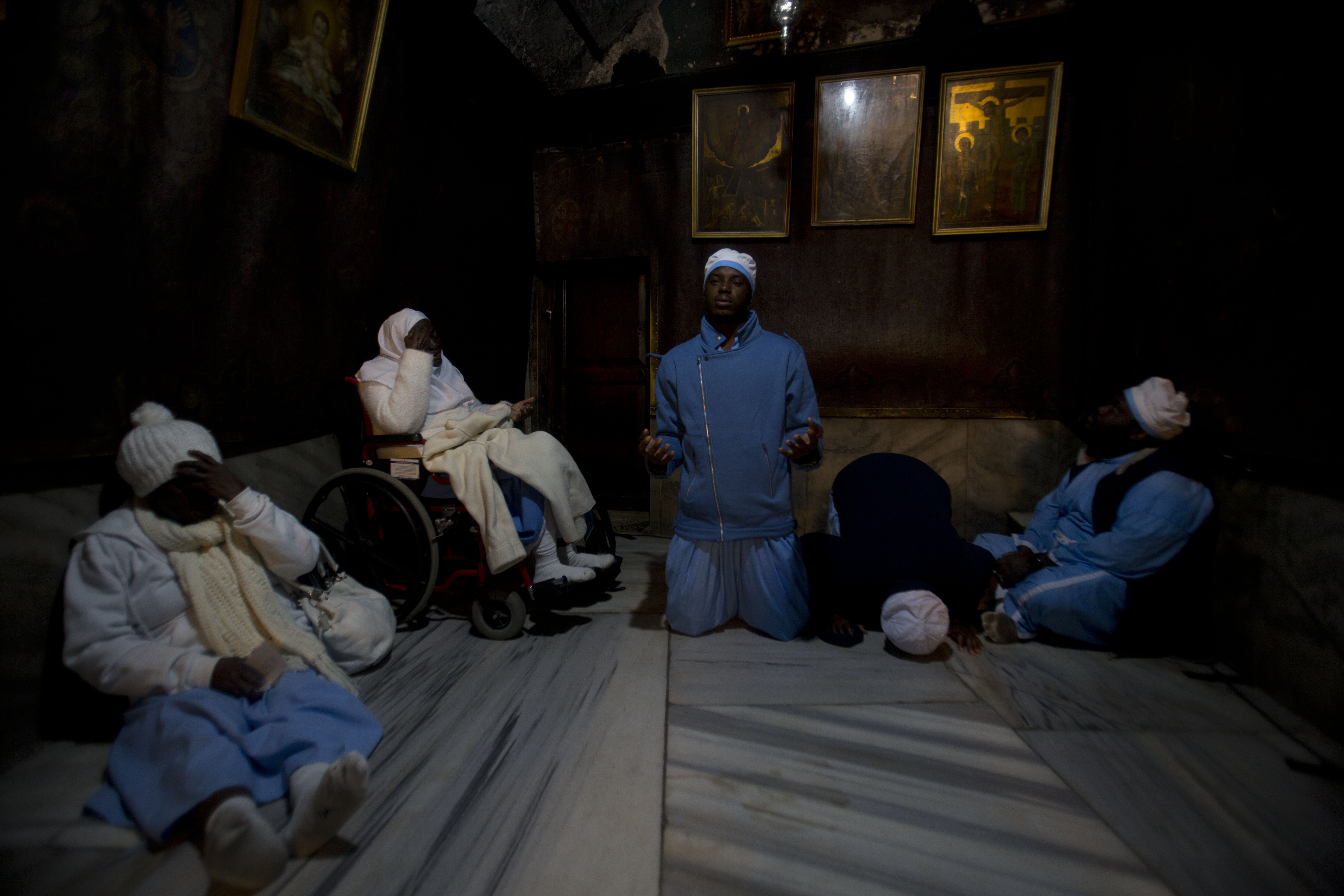 Christian pilgrims from Nigeria pray inside the Grotto of the Church of the Nativity, traditionally believed by Christians to be the birthplace of Jesus Christ, in the West Bank city of Bethlehem on Christmas Eve, Tuesday, Dec. 24, 2019. (AP Photo/Majdi Mohammed)