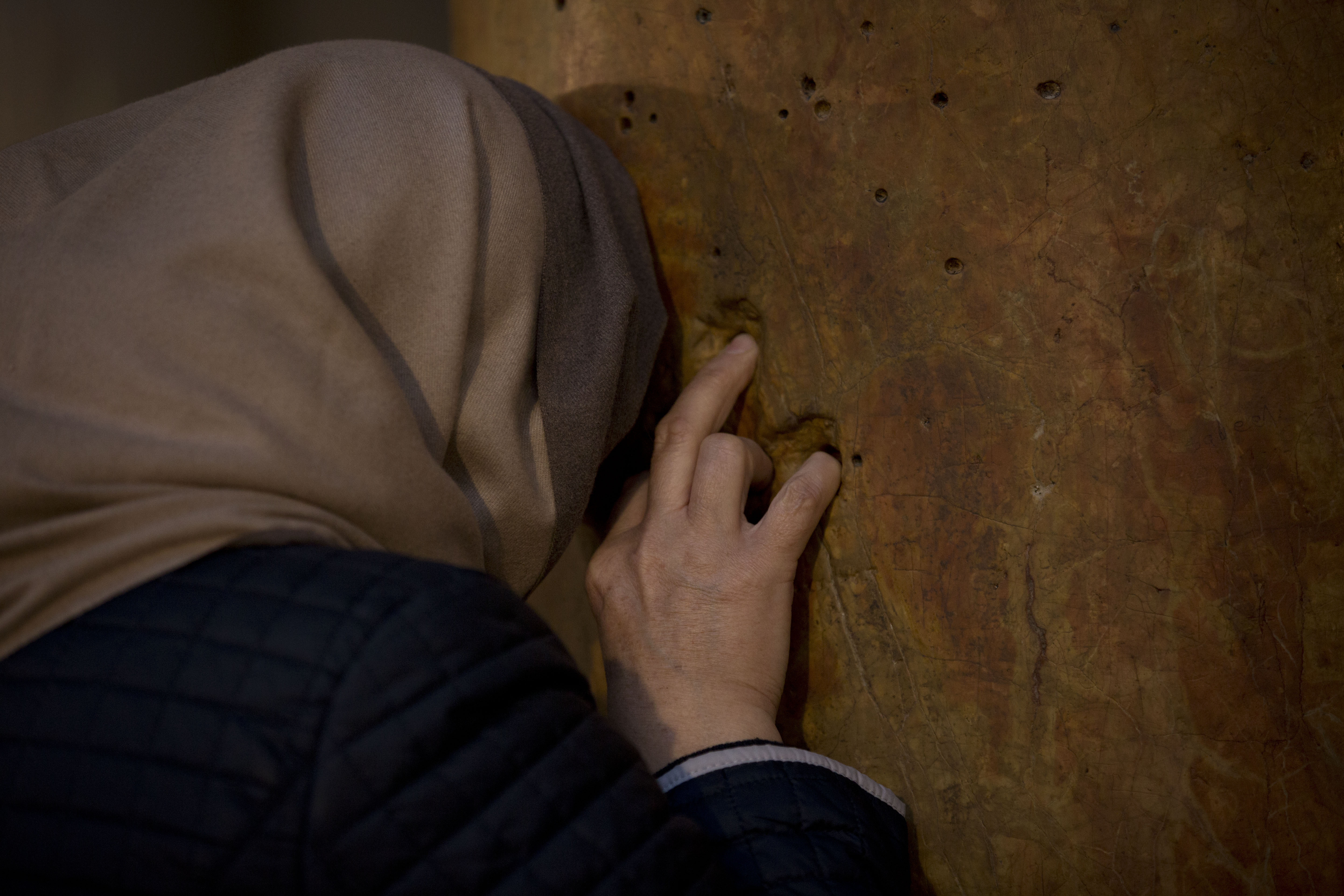 A worshipper prays inside the Church of the Nativity, built on top of the site where Christians believe Jesus Christ was born, on Christmas Eve, in the West Bank City of Bethlehem, Tuesday, Dec. 24, 2019. (AP Photo/Majdi Mohammed)