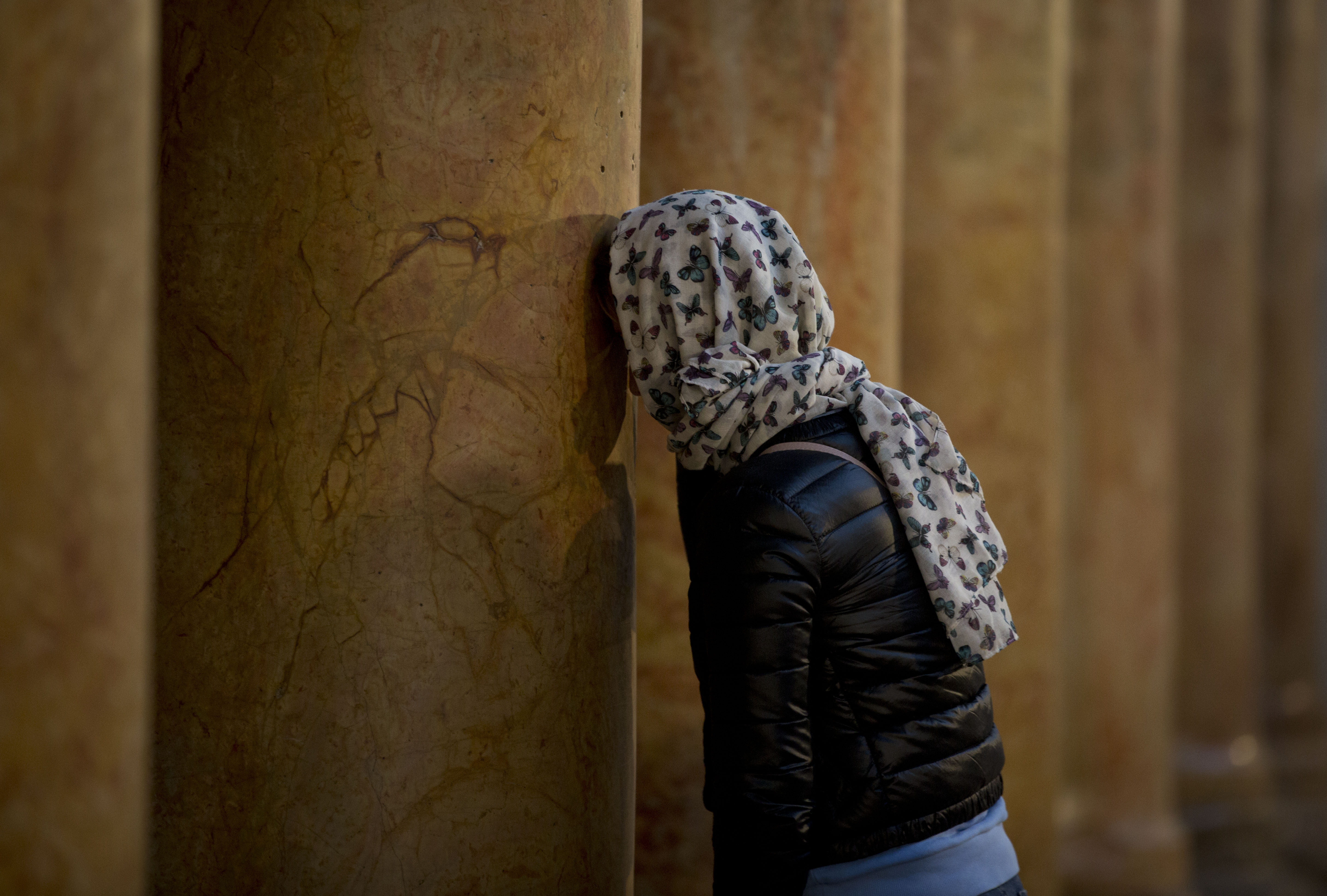 A worshipper prays inside the Church of the Nativity, built on top of the site where Christians believe Jesus Christ was born, on Christmas Eve, in the West Bank City of Bethlehem, Tuesday, Dec. 24, 2019. (AP Photo/Majdi Mohammed)