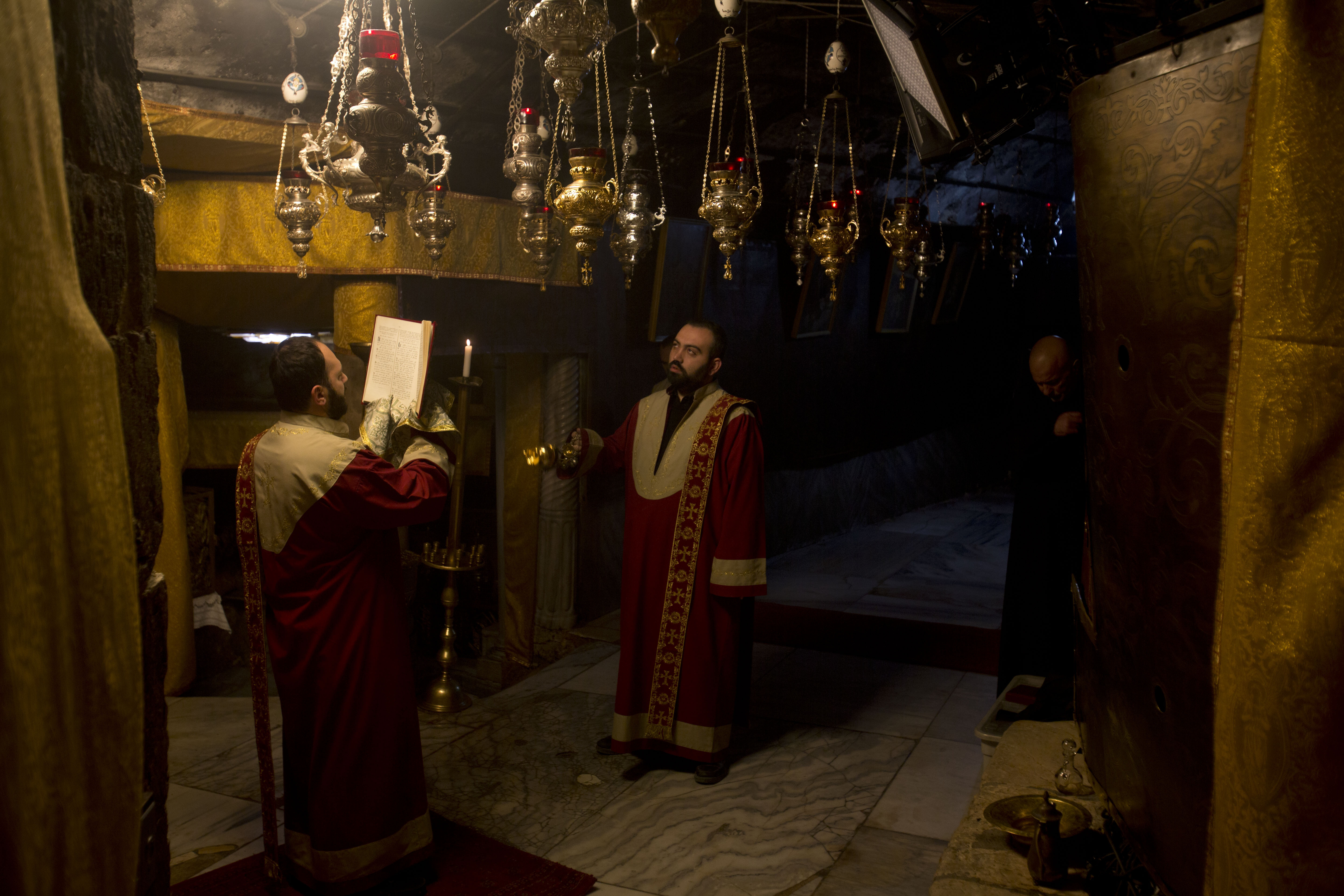 Christian Armenian pray inside the Grotto of the Church of the Nativity, traditionally believed by Christians to be the birthplace of Jesus Christ, in the West Bank city of Bethlehem on Christmas Eve, Tuesday, Dec. 24, 2019. (AP Photo/Majdi Mohammed)