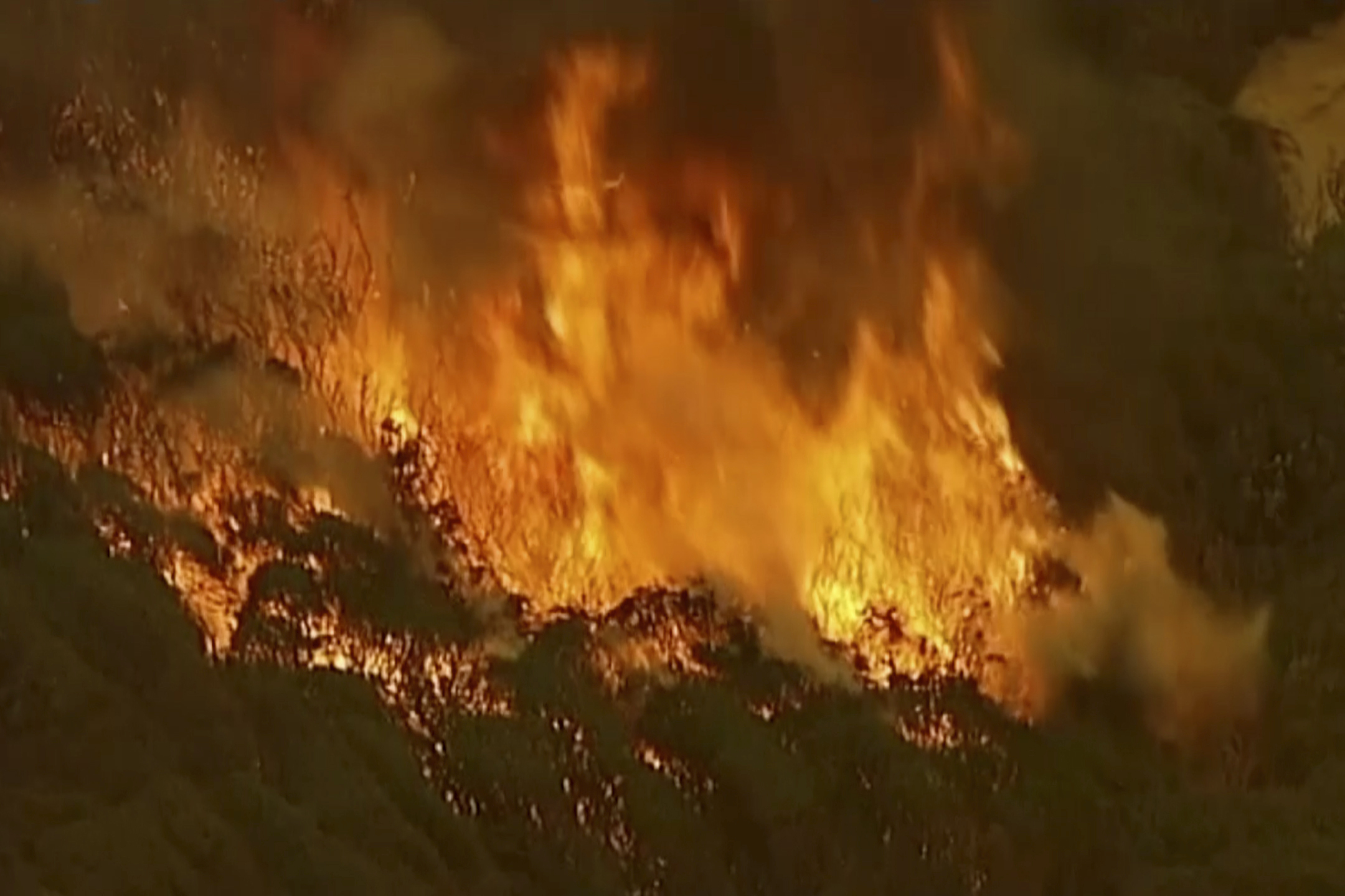 In this image made from video, an aerial scene shows fires burning in East Grippsland, Victoria state, Tuesday, Dec. 31, 2019. Wildfires burning across Australia's two most-populous states Tuesday trapped residents of a seaside town in apocalyptic conditions, destroyed many properties. (Australian Broadcasting Corporation, Channel 7, Channel 9 via AP)