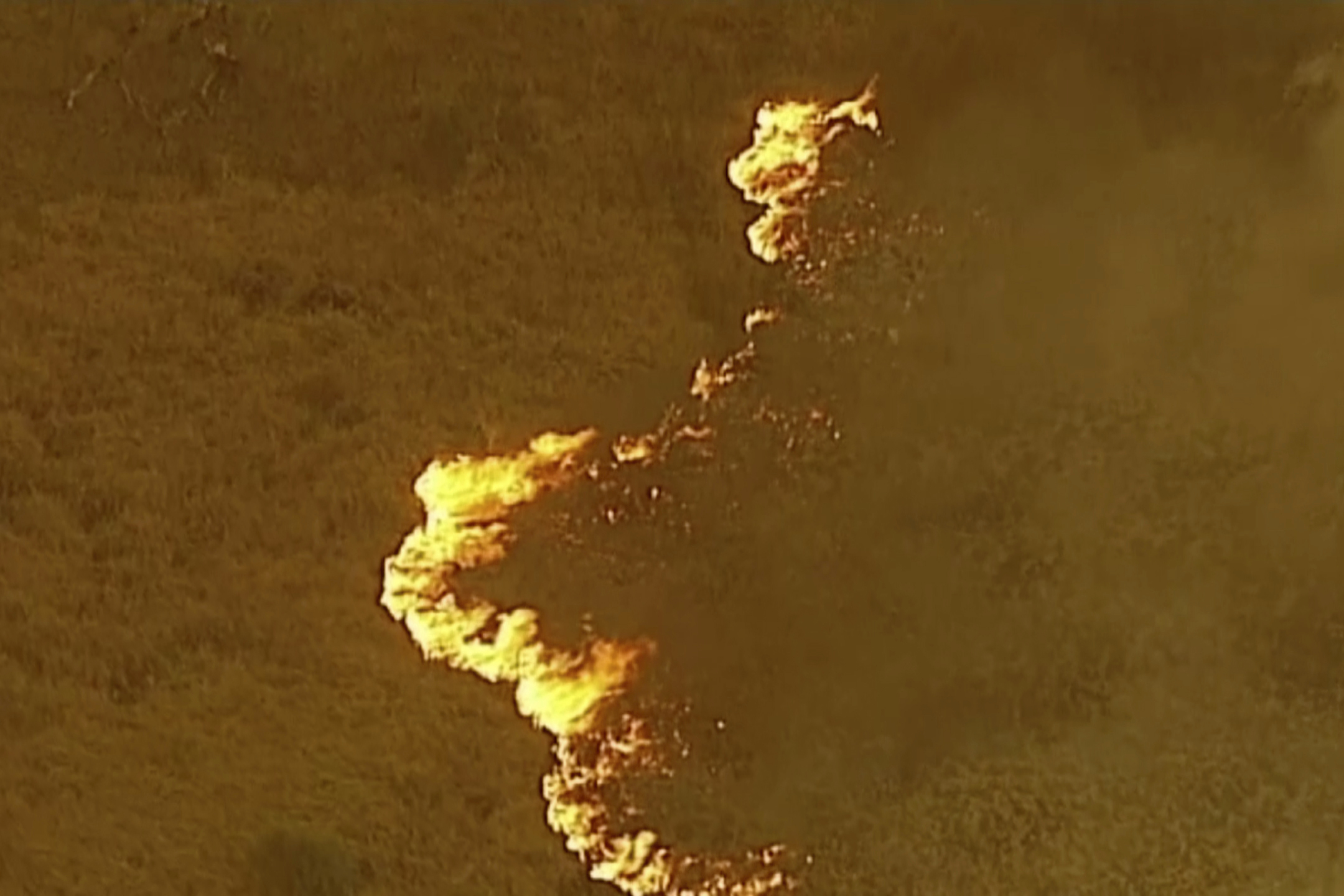 In this image made from video, an aerial scene shows fires burning in East Grippsland, Victoria state, Tuesday, Dec. 31, 2019. Wildfires burning across Australia's two most-populous states Tuesday trapped residents of a seaside town in apocalyptic conditions, destroyed many properties. (Australian Broadcasting Corporation, Channel 7, Channel 9 via AP)