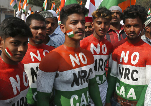 Indians, their bodies painted in the colors of the national flag, participate in a protest against a new citizenship law that opponents say threatens India's secular identity, in Hyderabad, India, Friday, Jan. 10, 2020. The new citizenship law and a proposed National Register of Citizens have brought thousands of protesters out in the streets in many cities and towns since Parliament approved the measure on Dec. 11, leaving more than 20 dead in clashes between security forces and the protesters. (AP Photo/Mahesh Kumar A.)
