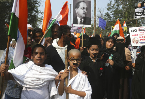 An Indian child dressed like Mahatma Gandhi participates in a protest against a new citizenship law that opponents say threatens India's secular identity, in Hyderabad, India, Friday, Jan. 10, 2020. The new citizenship law and a proposed National Register of Citizens have brought thousands of protesters out in the streets in many cities and towns since Parliament approved the measure on Dec. 11, leaving more than 20 dead in clashes between security forces and the protesters. (AP Photo/Mahesh Kumar A.)