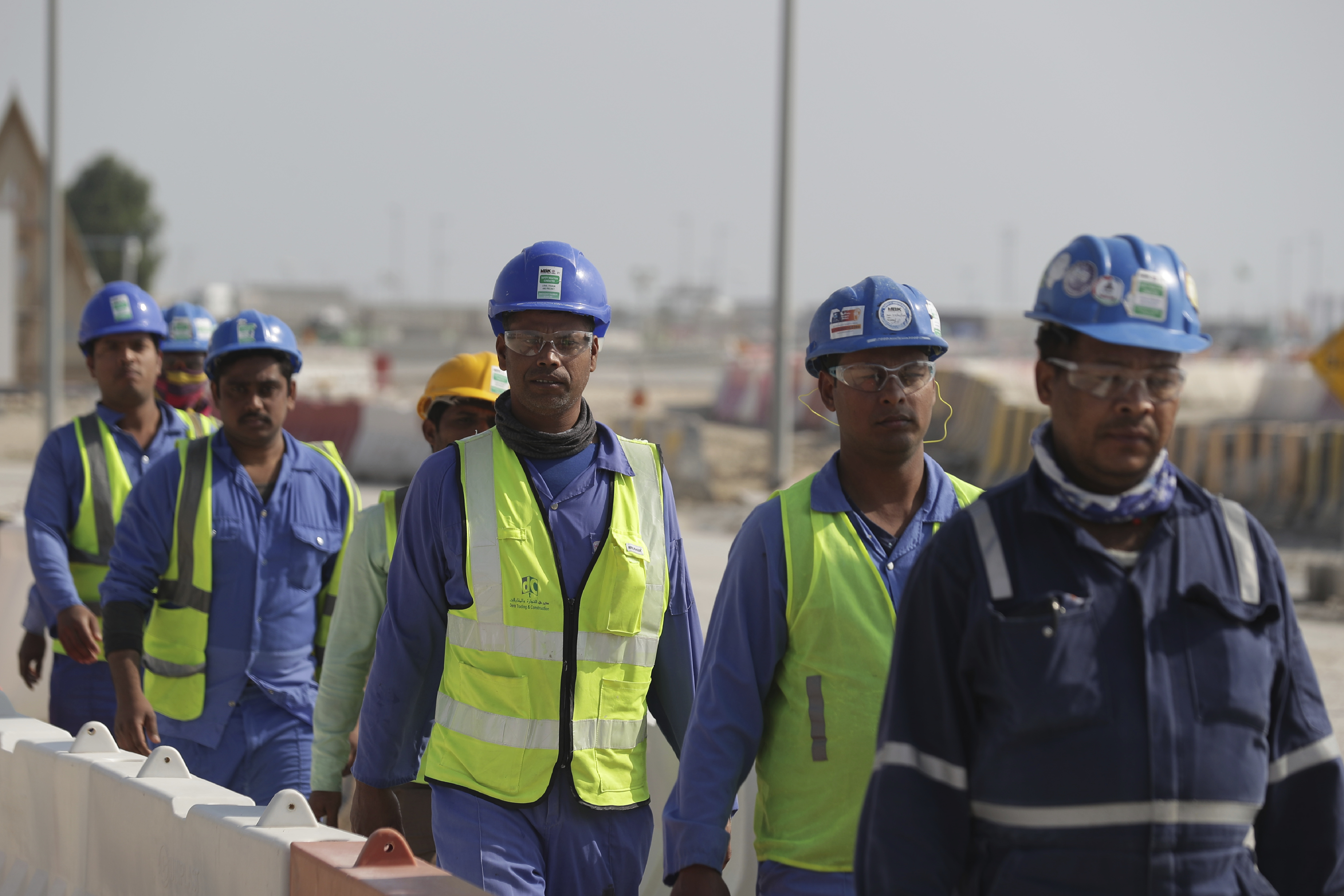 Workers walk to the Lusail Stadium, one of the 2022 World Cup stadiums, in Lusail, Qatar, Friday, Dec. 20, 2019. Construction is underway to complete Lusail's 80,000-seat venue for the opening game and final in a city that didn't exist when Qatar won the FIFA vote in 2010. (AP Photo/Hassan Ammar)