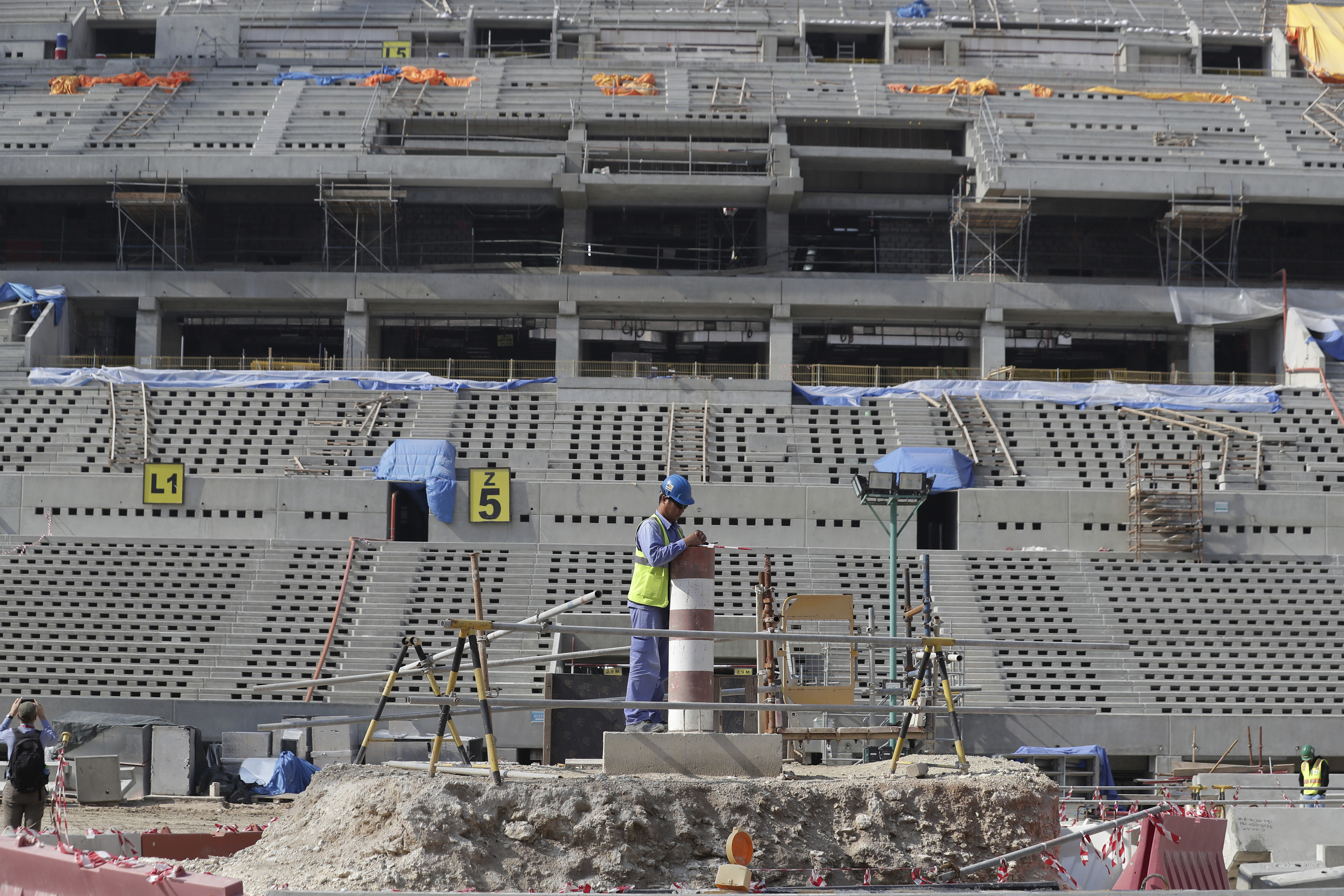 Workers work at Lusail Stadium, one of the 2022 World Cup stadiums, in Lusail, Qatar, Friday, Dec. 20, 2019. Construction is underway to complete Lusail's 80,000-seat venue for the opening game and final in a city that didn't exist when Qatar won the FIFA vote in 2010. (AP Photo/Hassan Ammar)